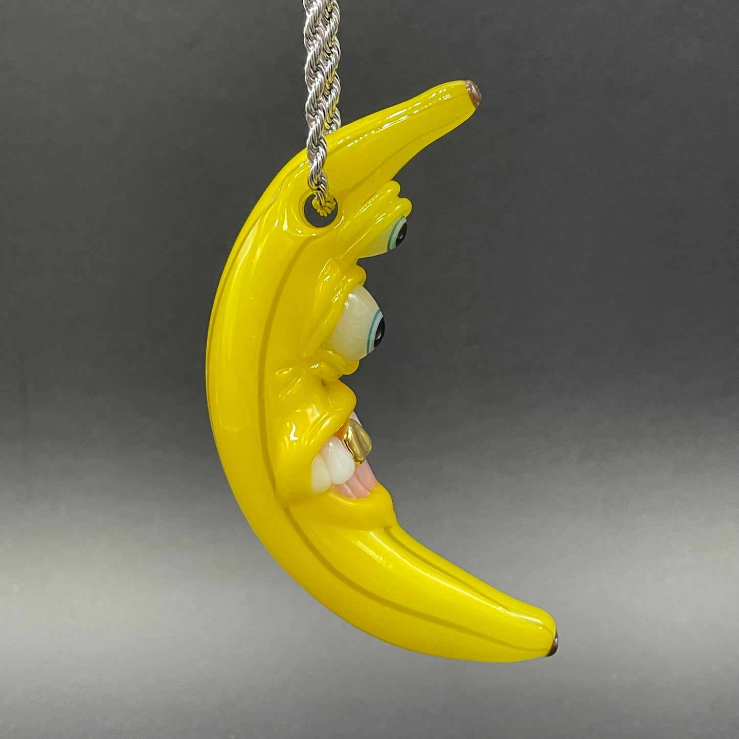 Grinning glass banana pendant