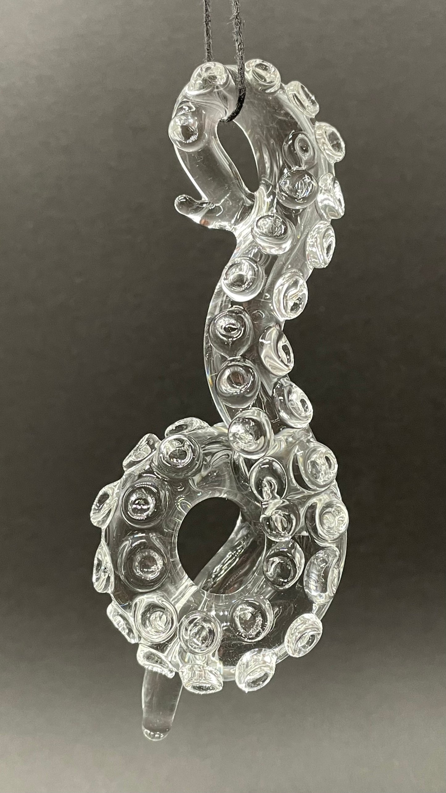 Close-up of 3 clear tentacle ornaments - handcrafted glass