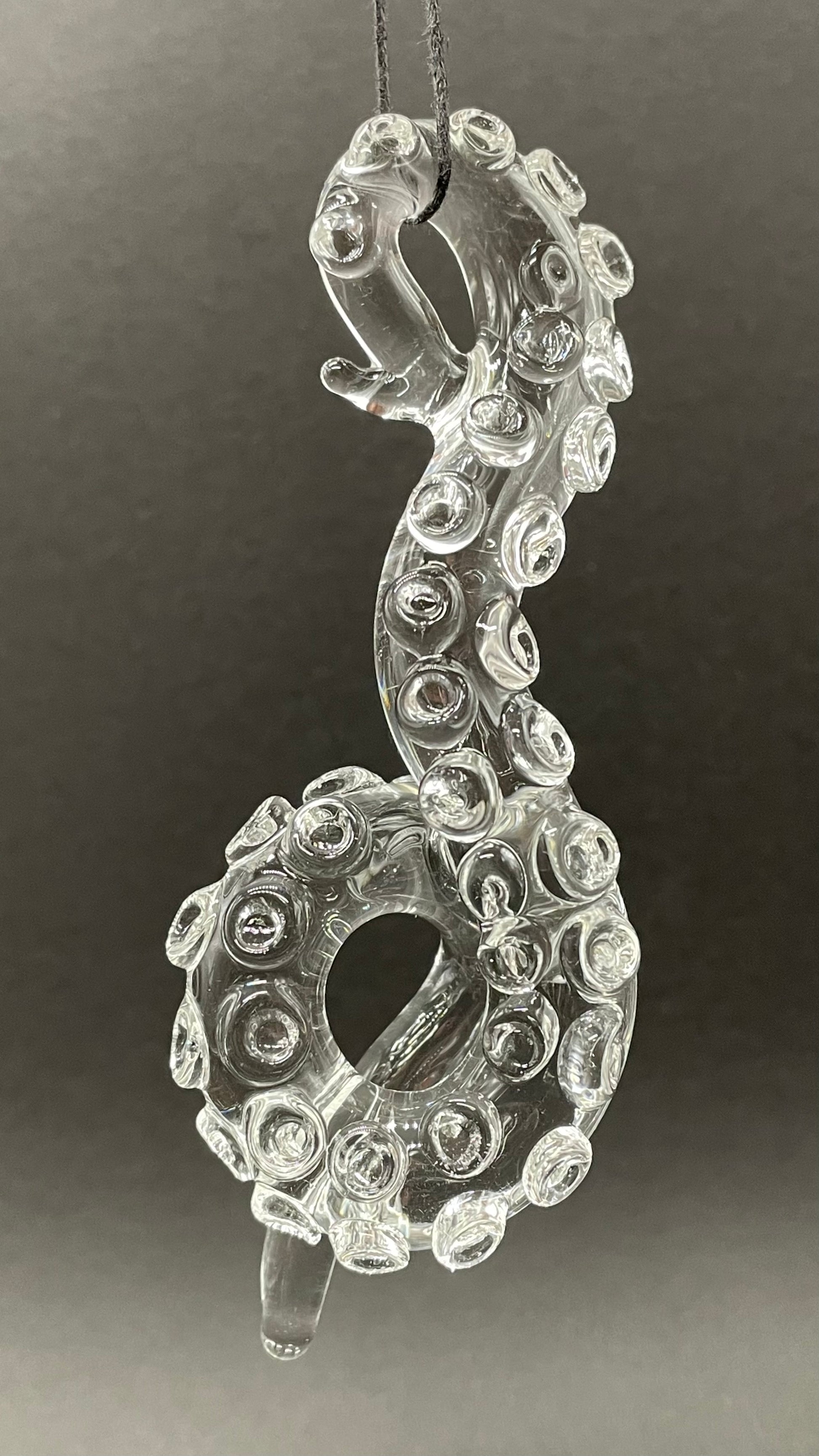 Close-up of 3 clear tentacle ornaments - handcrafted glass