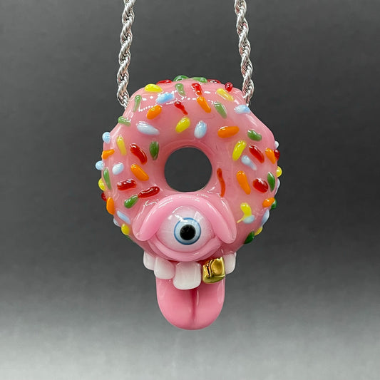 Mmmm Doughnuts handblown glass pendant - pink frosted donut with multicolor sprinkles, cyclops eye, white teeth, gold tooth, pink tongue, silver rope chain - Leviathan Glass