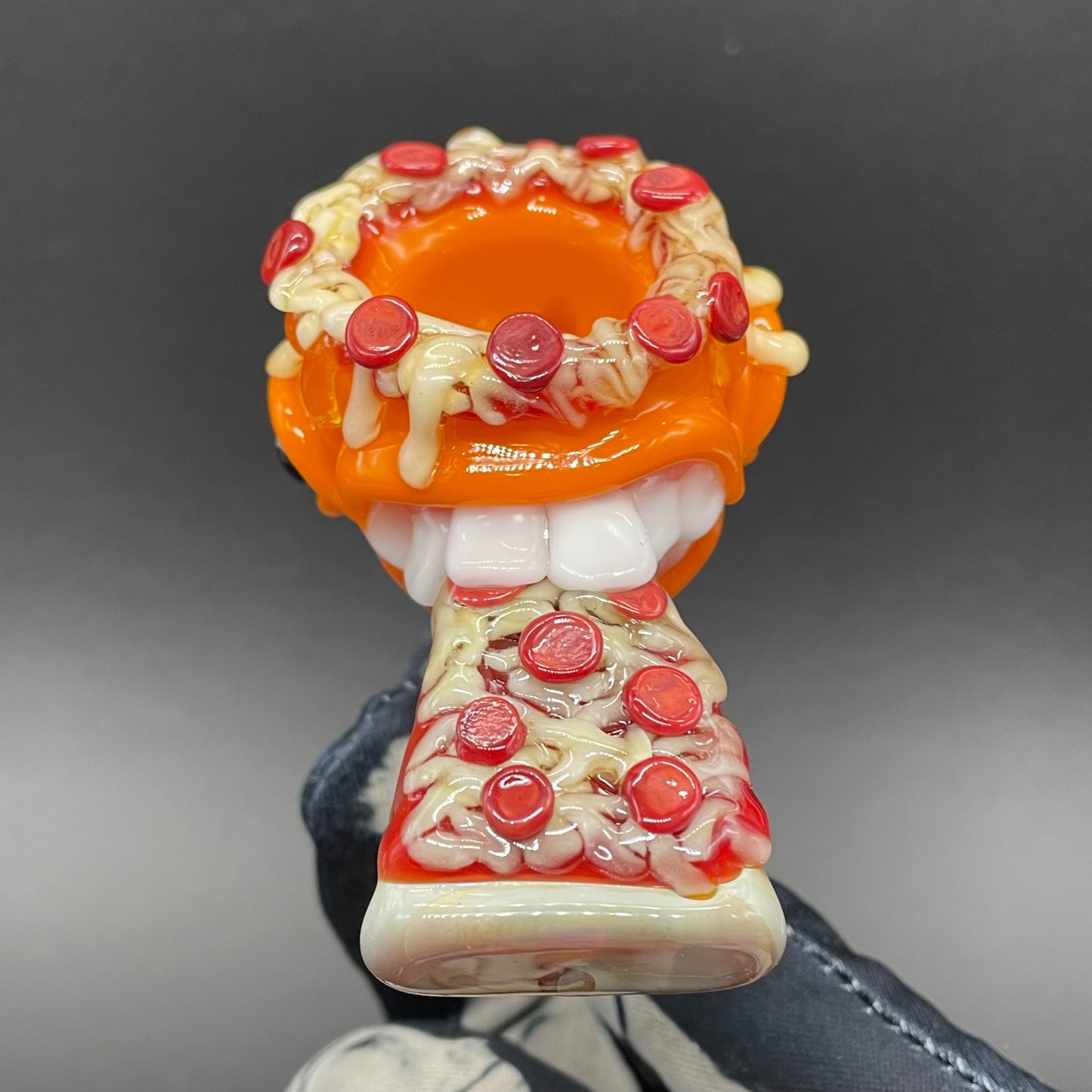 Close-up of 14mm 4 hole orange pizza fiend slide - handcrafted glass
