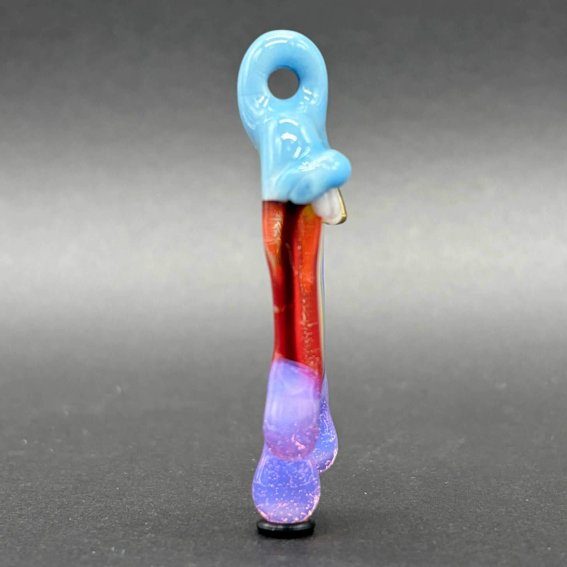 Drippy tongue rainbow tongue pendant by Leviathan Glass - artisan detail