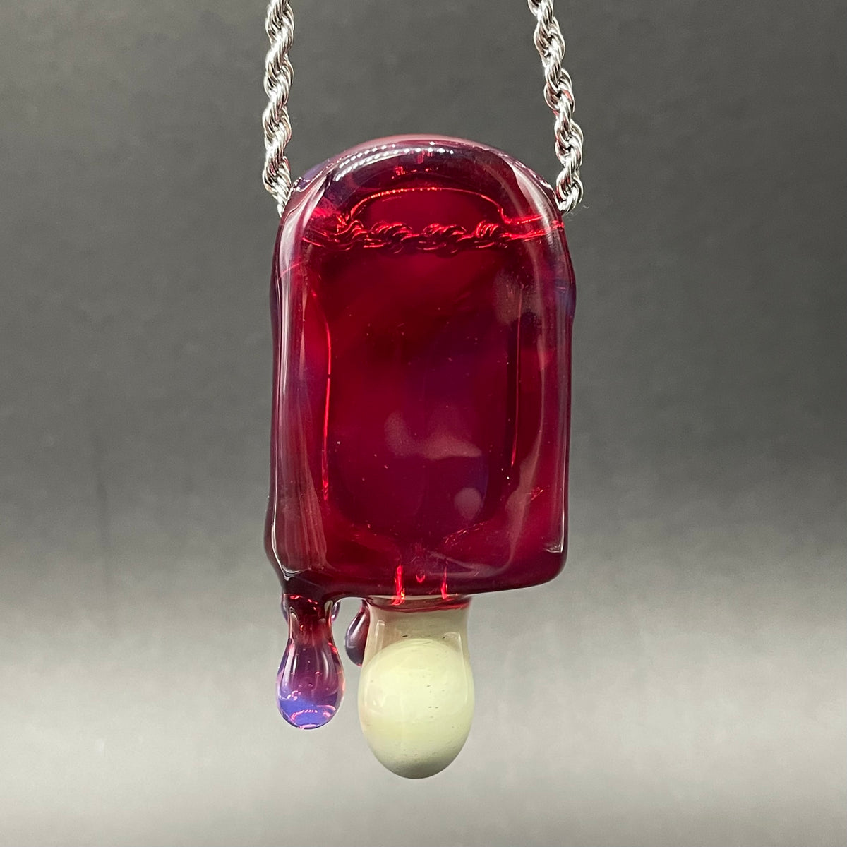 Close-up of Drippy popsicle pendant - handcrafted glass