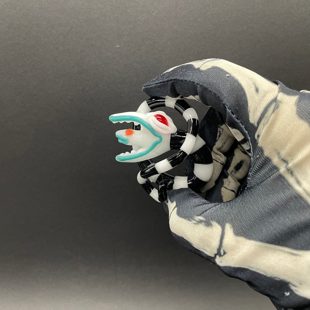 Beetlejuice Inspired handblown solid glass Sandworm sculpture - coiled black and white striped sandworm with white worm head, teal tongue, red eyes - Leviathan Glass