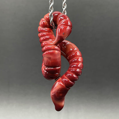 Close-up of glass earthworm pendant - handcrafted glass