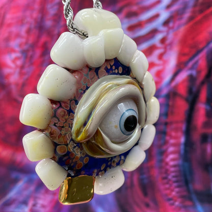 Unidentified Object Delta handblown glass pendant - circular disc ringed with ivory teeth, blue iris eye center, eyelid, gold tooth accent, silver rope chain - Leviathan Glass