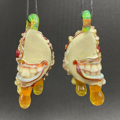 Close-up of Two halves of one pizza friendship necklace - handcrafted glass