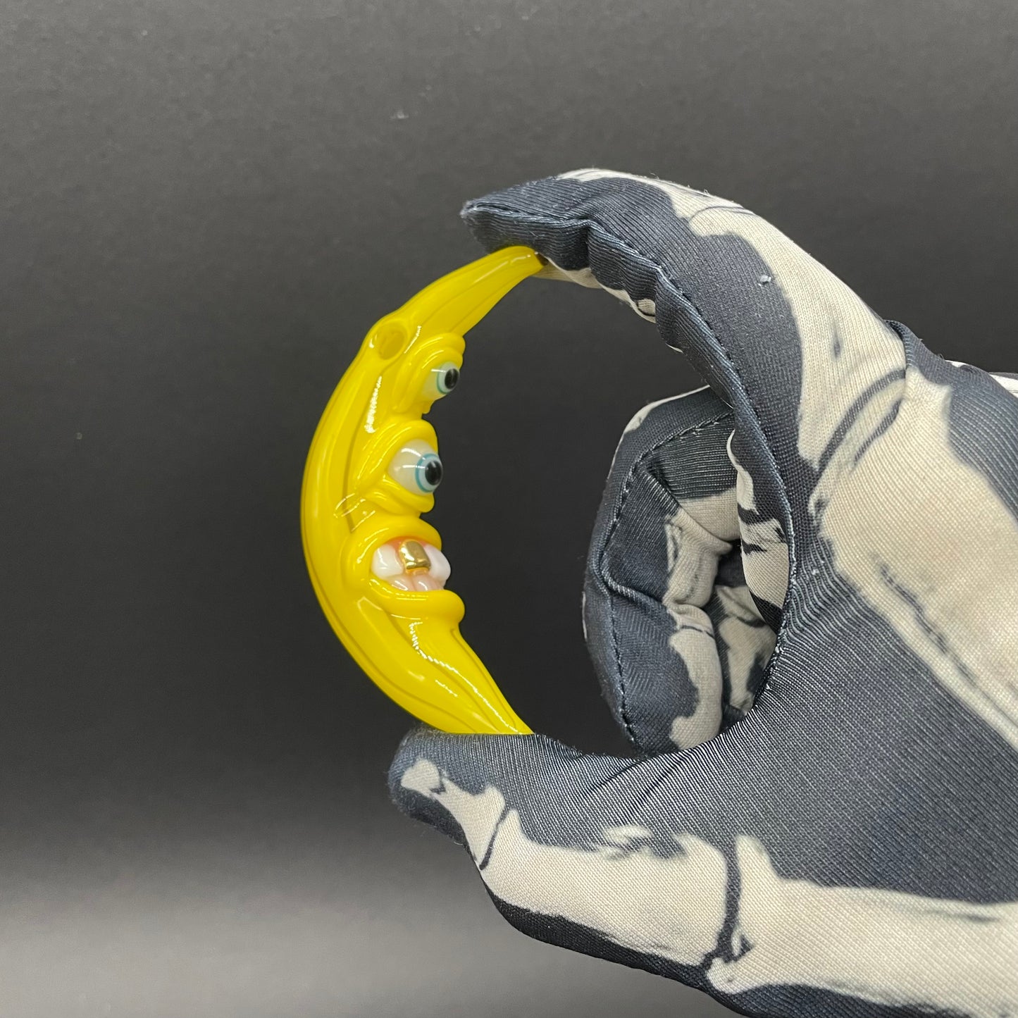 Grinning glass banana pendant