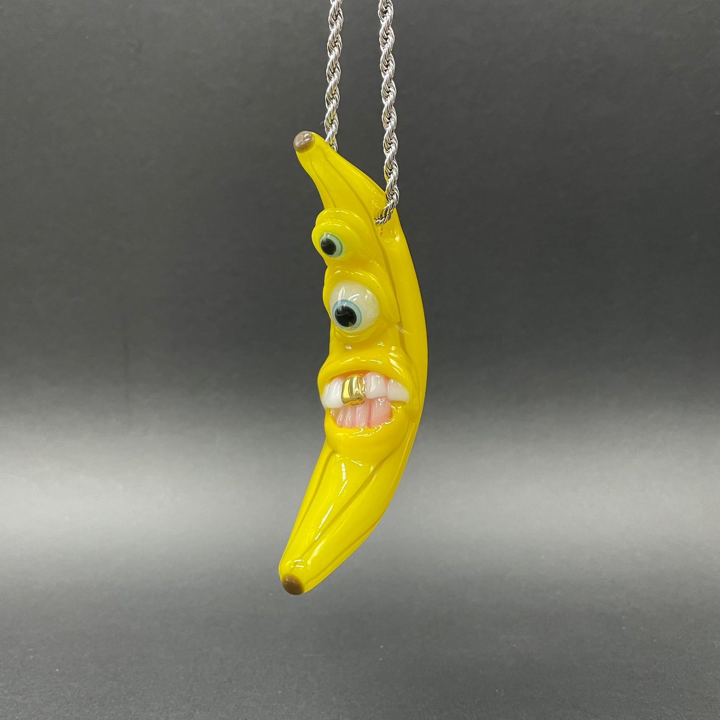 Grinning glass banana pendant