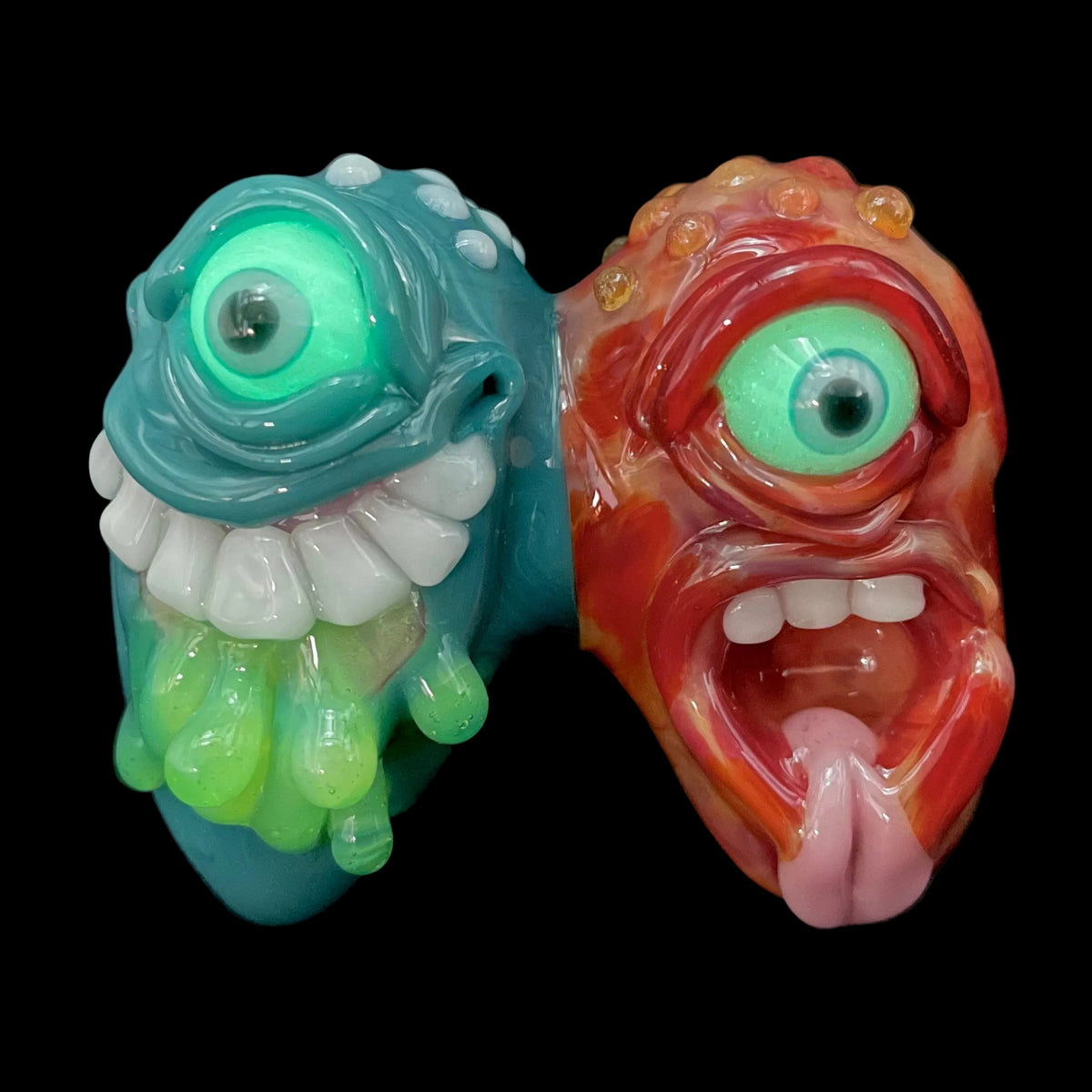 Two Headaches Are Better Than One handblown glass pendant - teal cyclops head with white teeth and green slime fused with red cyclops head with pink tongue, silver rope chain - Leviathan Glass