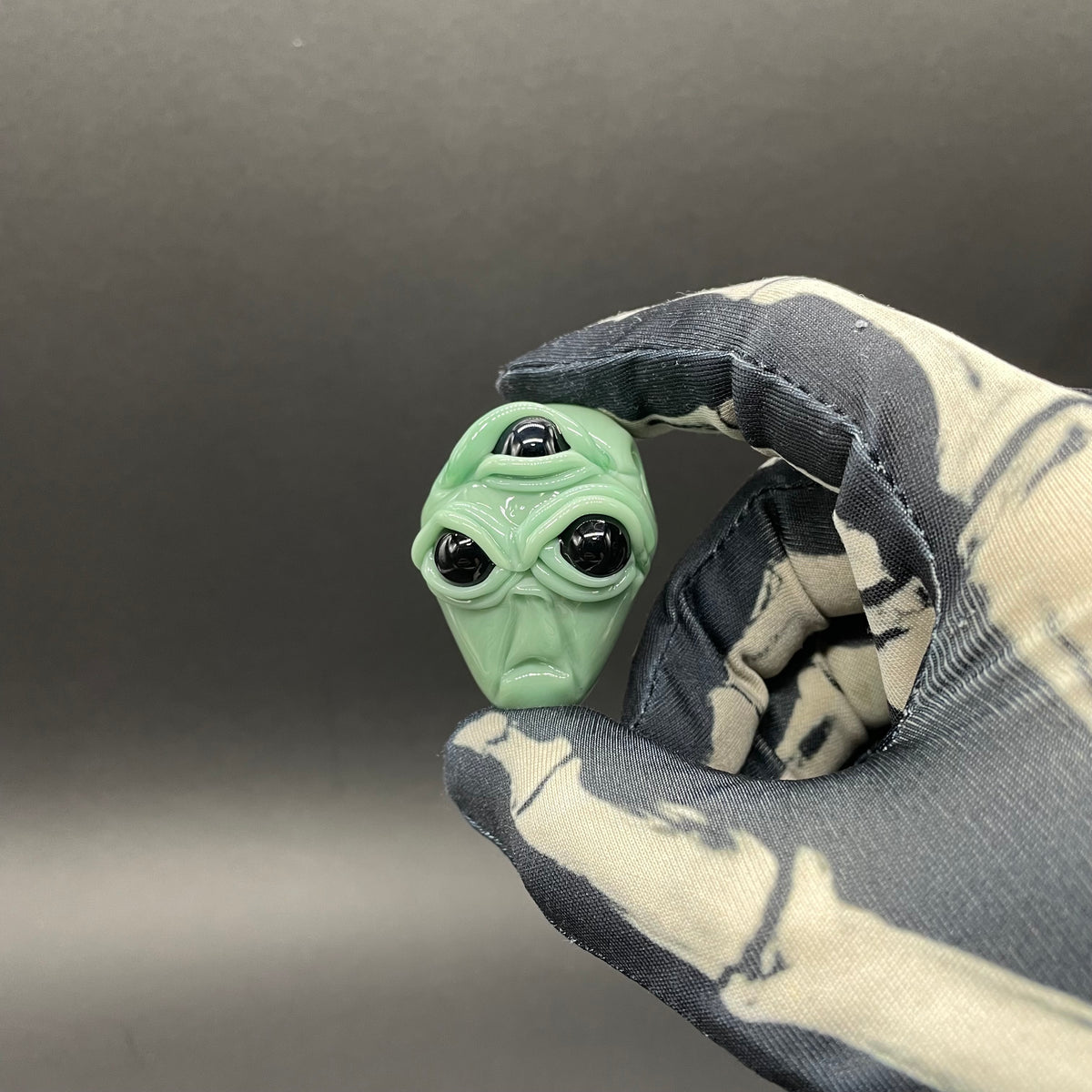 Time manipulating three eye glass alien pendant