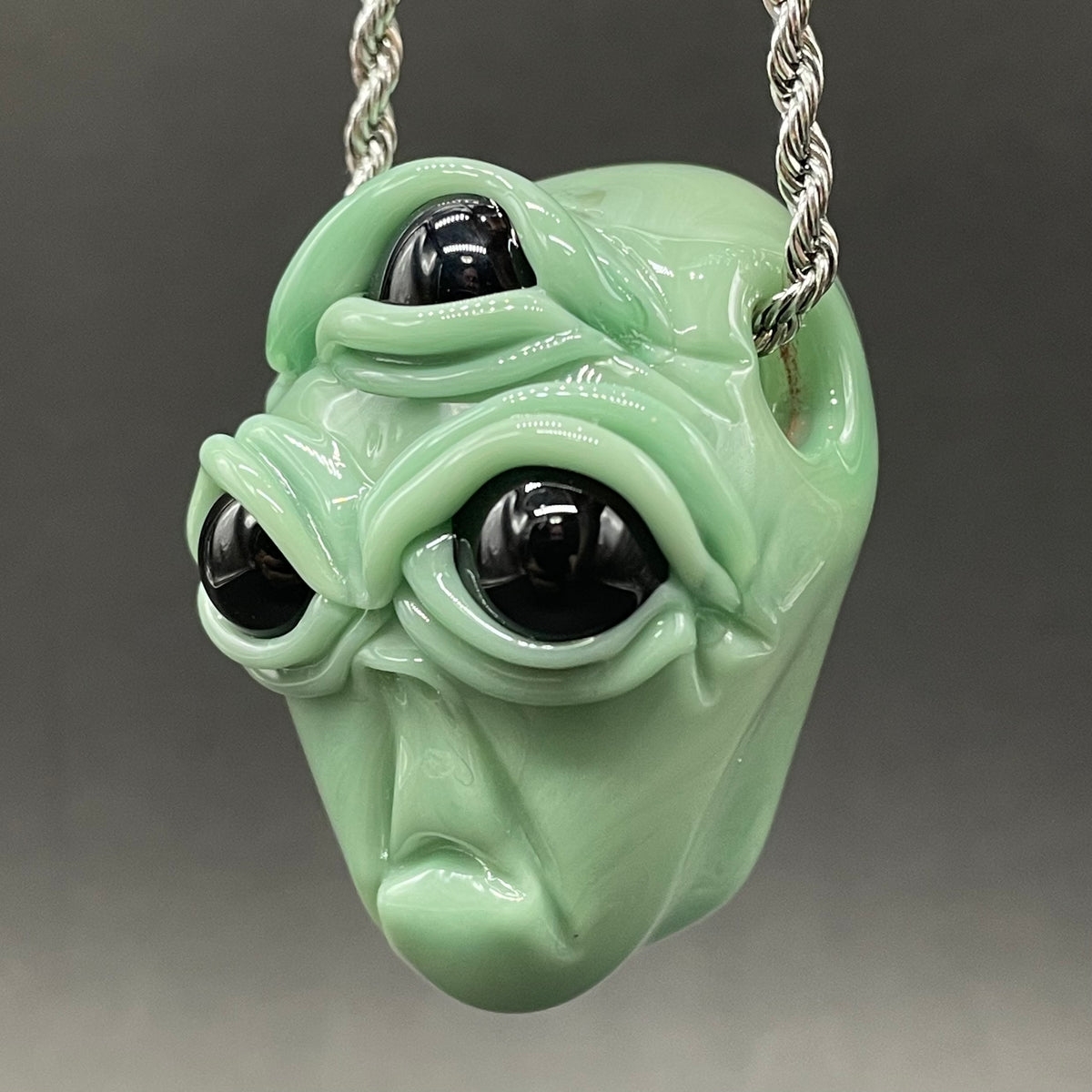 Time manipulating three eye glass alien pendant