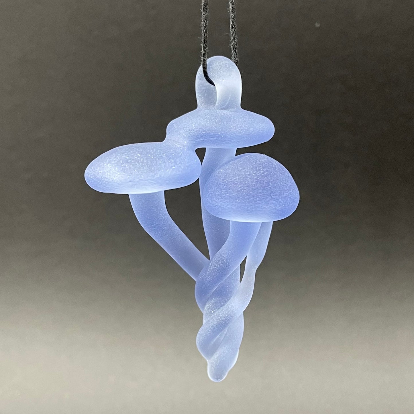 Blacklight mushroom pendant by Leviathan Glass - artisan detail
