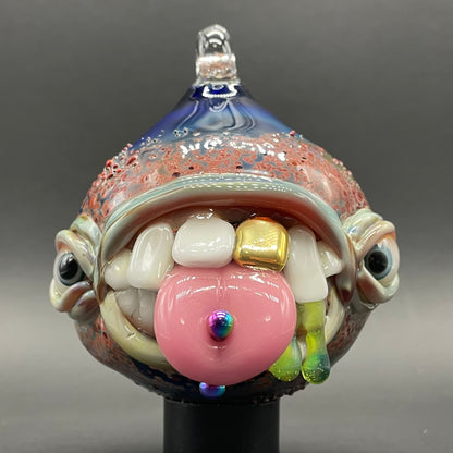 Close-up of Pierced tongue cyclops ornament - handcrafted glass