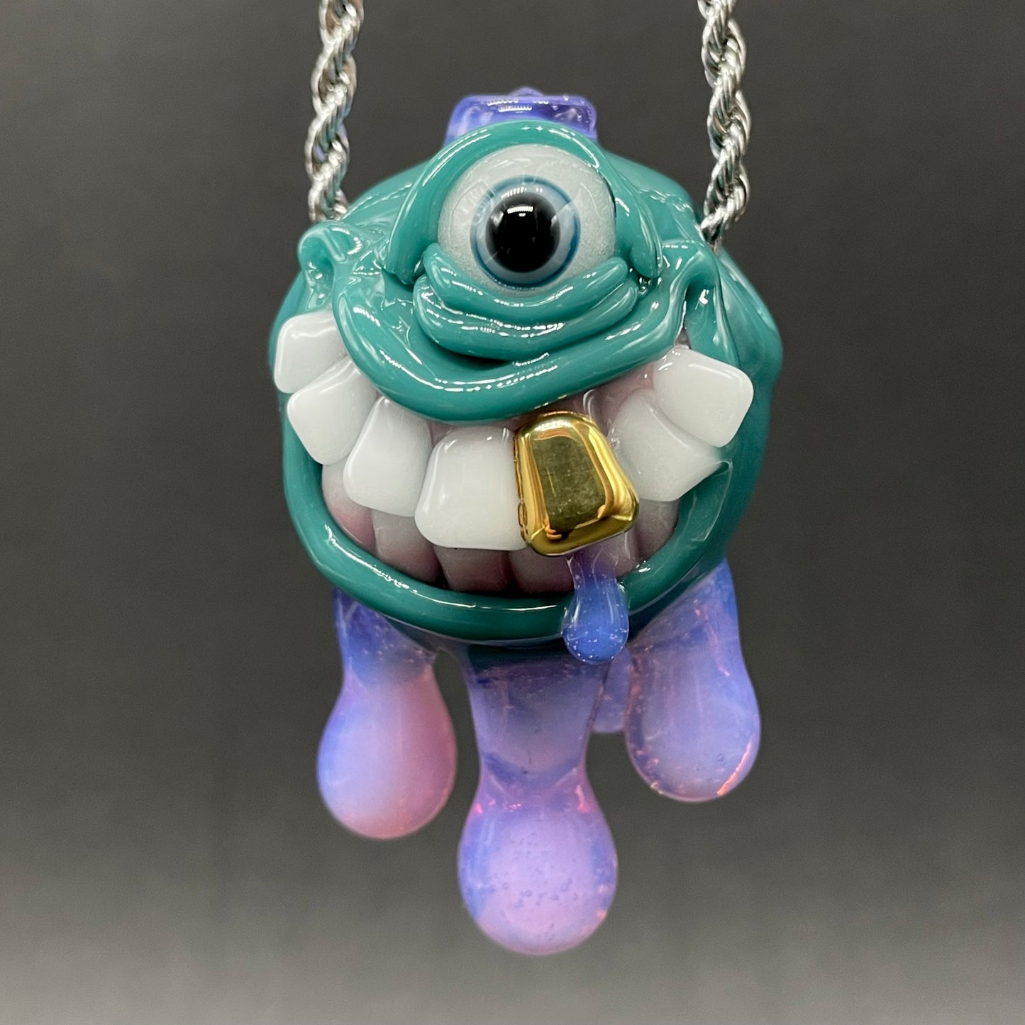 Close-up of Dripping with sarcasm glass pendant - handcrafted glass