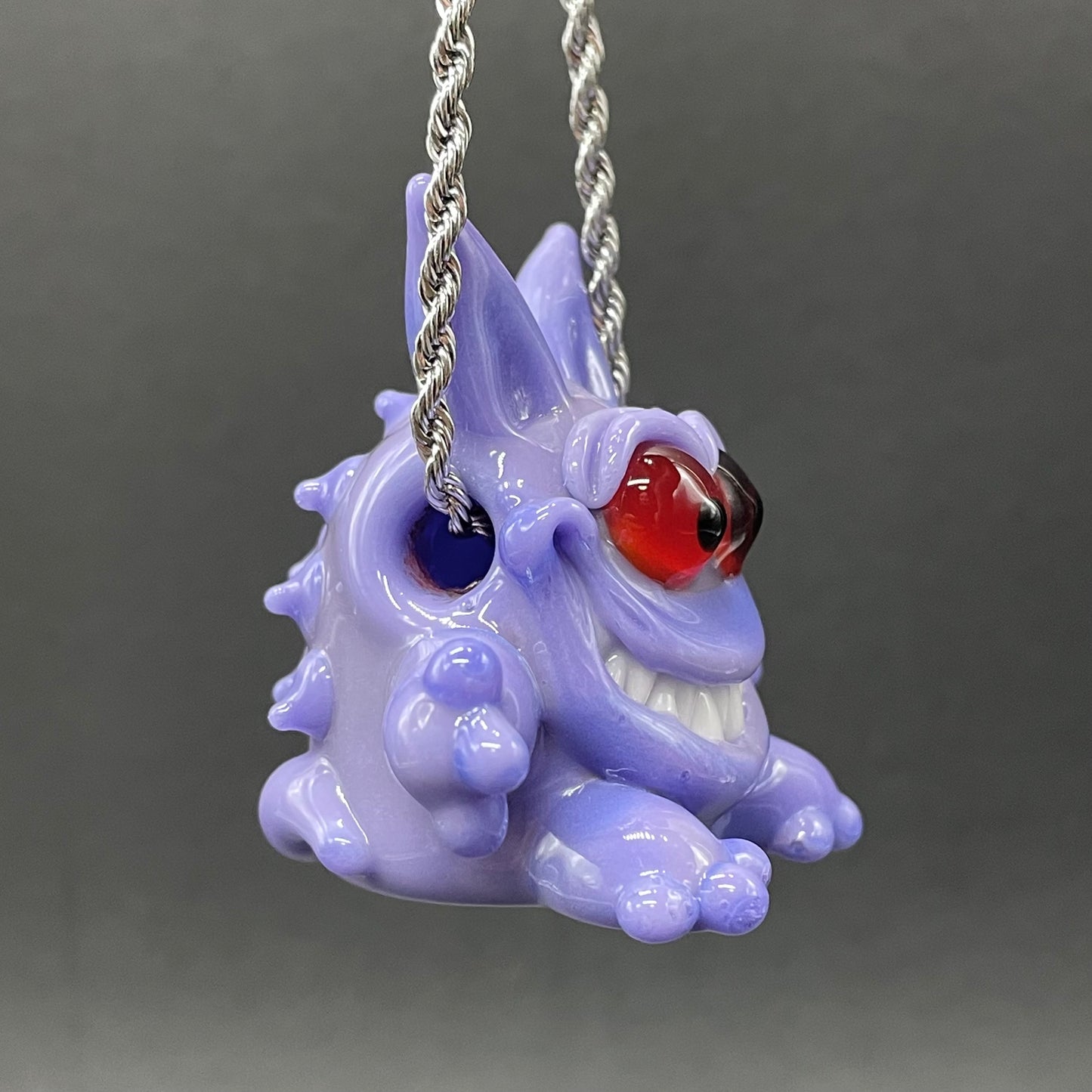 Gengar Pokémon handblown glass pendant - periwinkle purple Gengar sculpture, large red glass eyes, white teeth, clawed hands and feet, silver rope chain - Leviathan Glass
