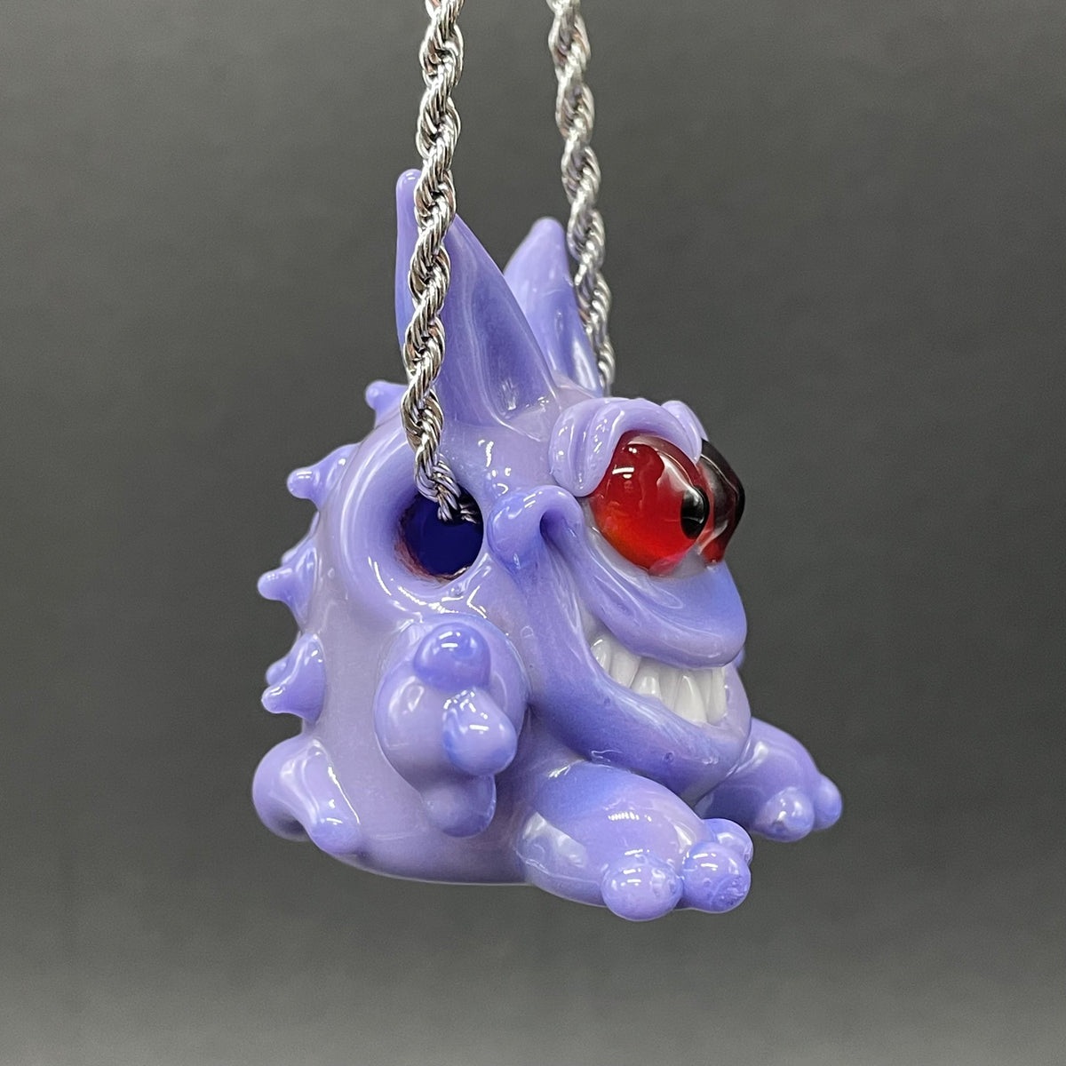 Gengar Pokémon handblown glass pendant - periwinkle purple Gengar sculpture, large red glass eyes, white teeth, clawed hands and feet, silver rope chain - Leviathan Glass