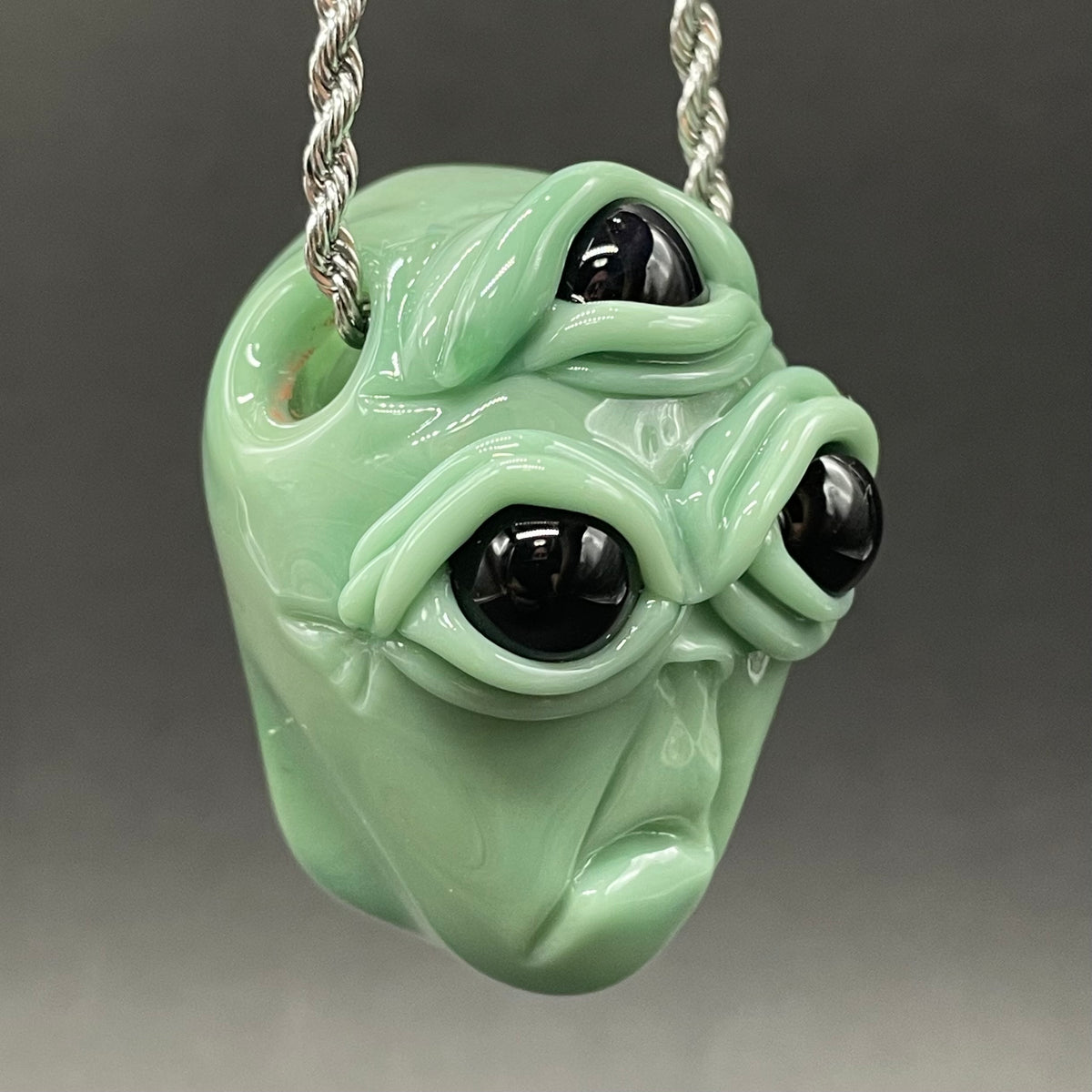 Time manipulating three eye glass alien pendant