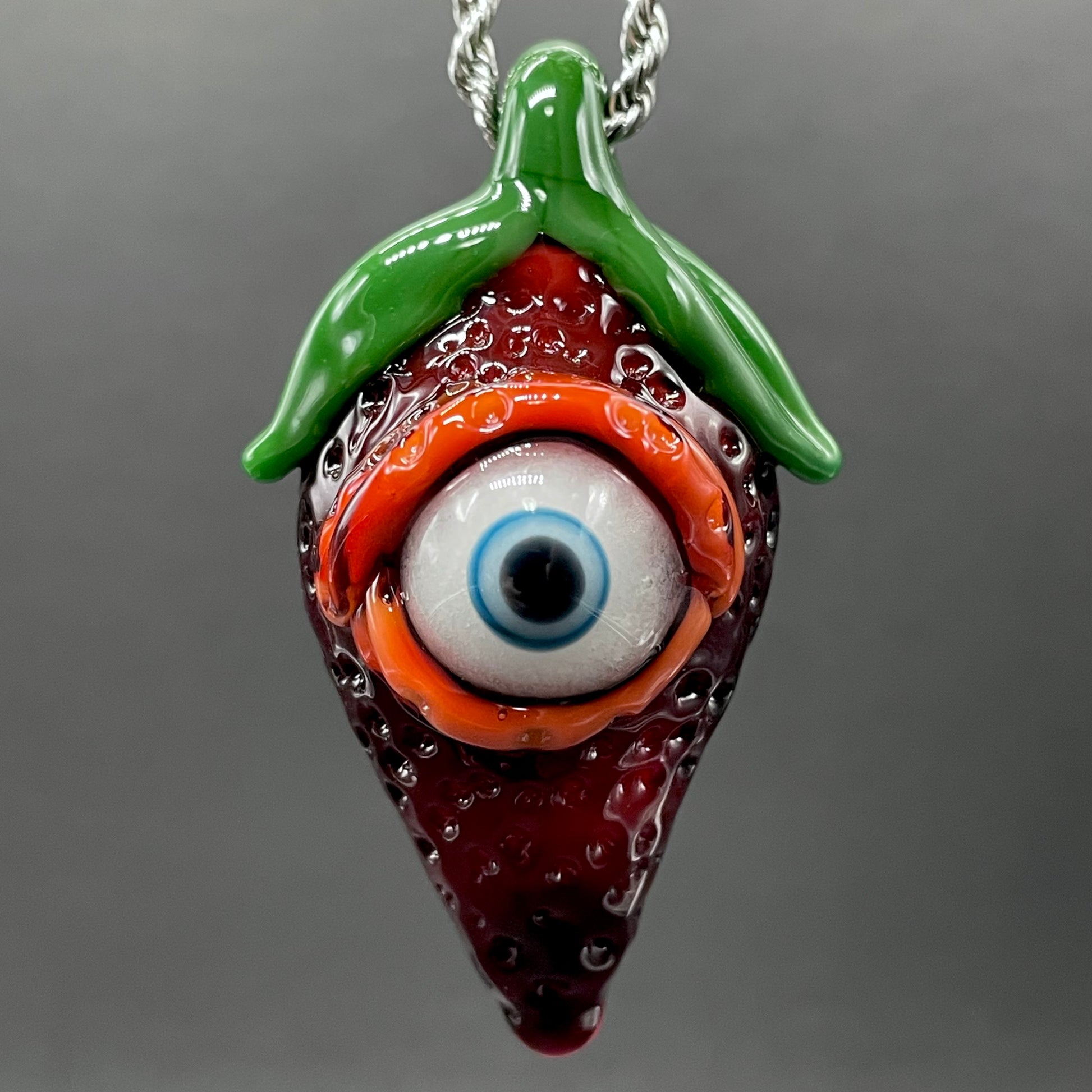 Cyclops strawberry pendant detail view - premium glass art