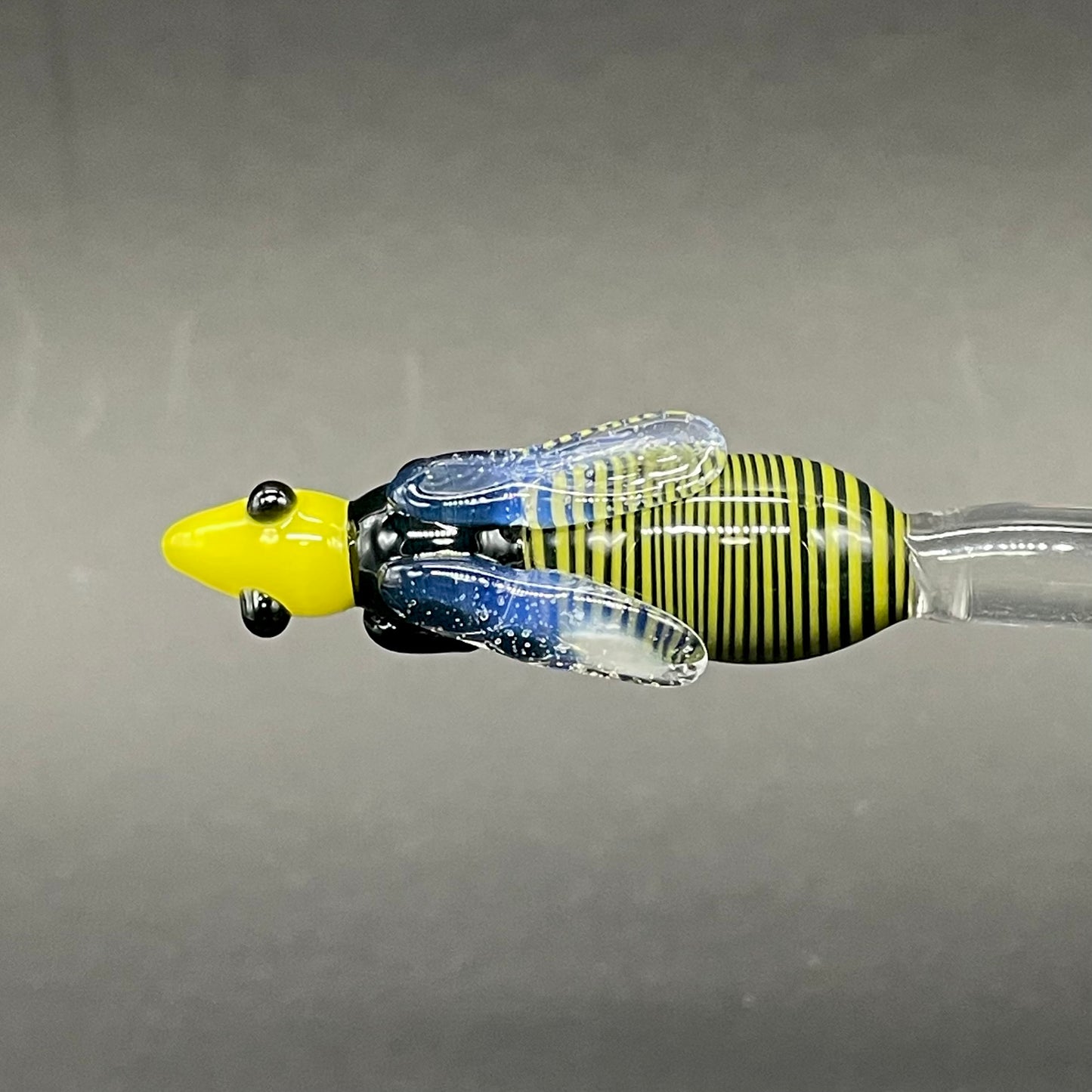 Close-up of Small glass Bee Honey Dipper - handcrafted glass