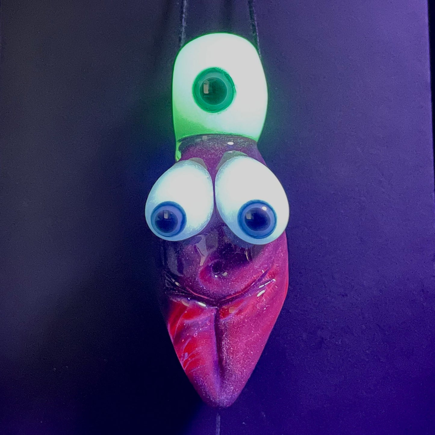 Black light reactive fertility pendant detail view - premium glass art