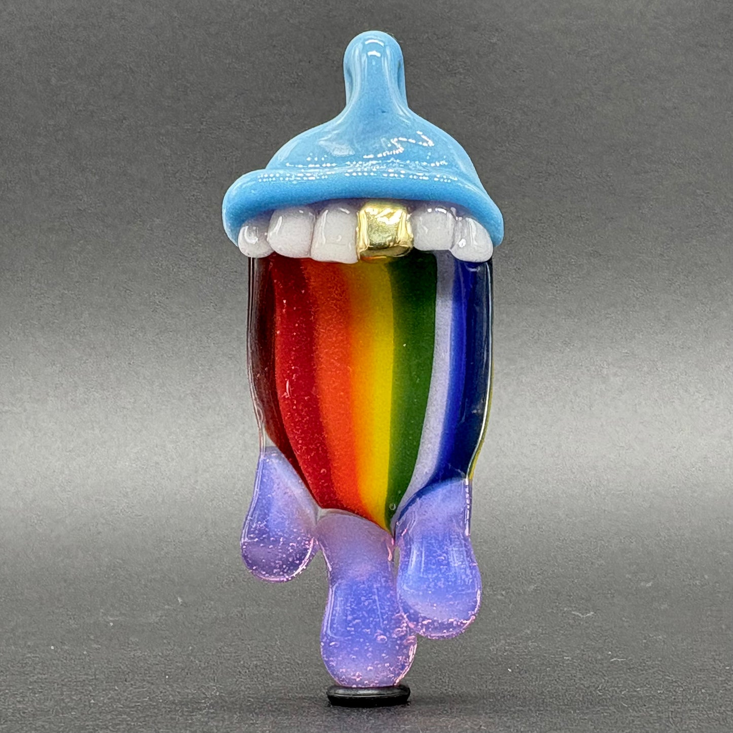 Close-up of Drippy tongue rainbow tongue pendant - handcrafted glass