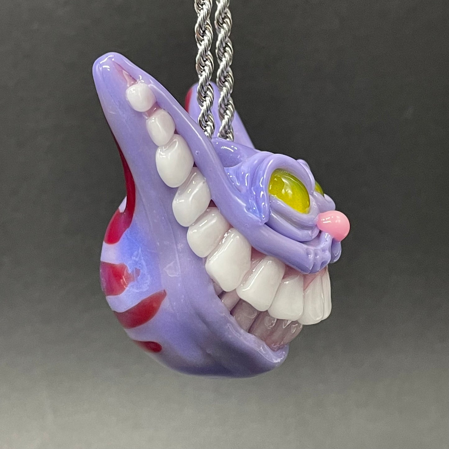 Grinning Cheshire cat glass pendant