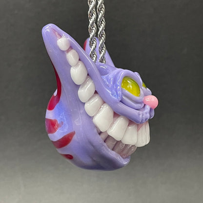 Grinning Cheshire cat glass pendant