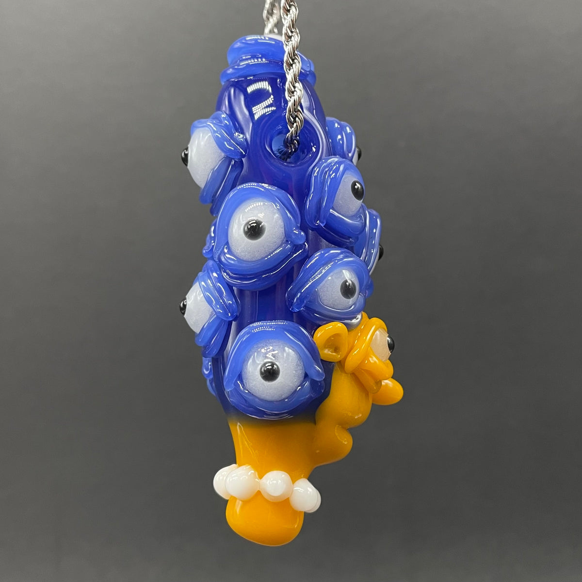 Marge Simpson Mutant handblown glass pendant - yellow Marge Simpson face with towering stack of blue cyclops creatures forming her hair, white pearl beads, silver rope chain - Leviathan Glass