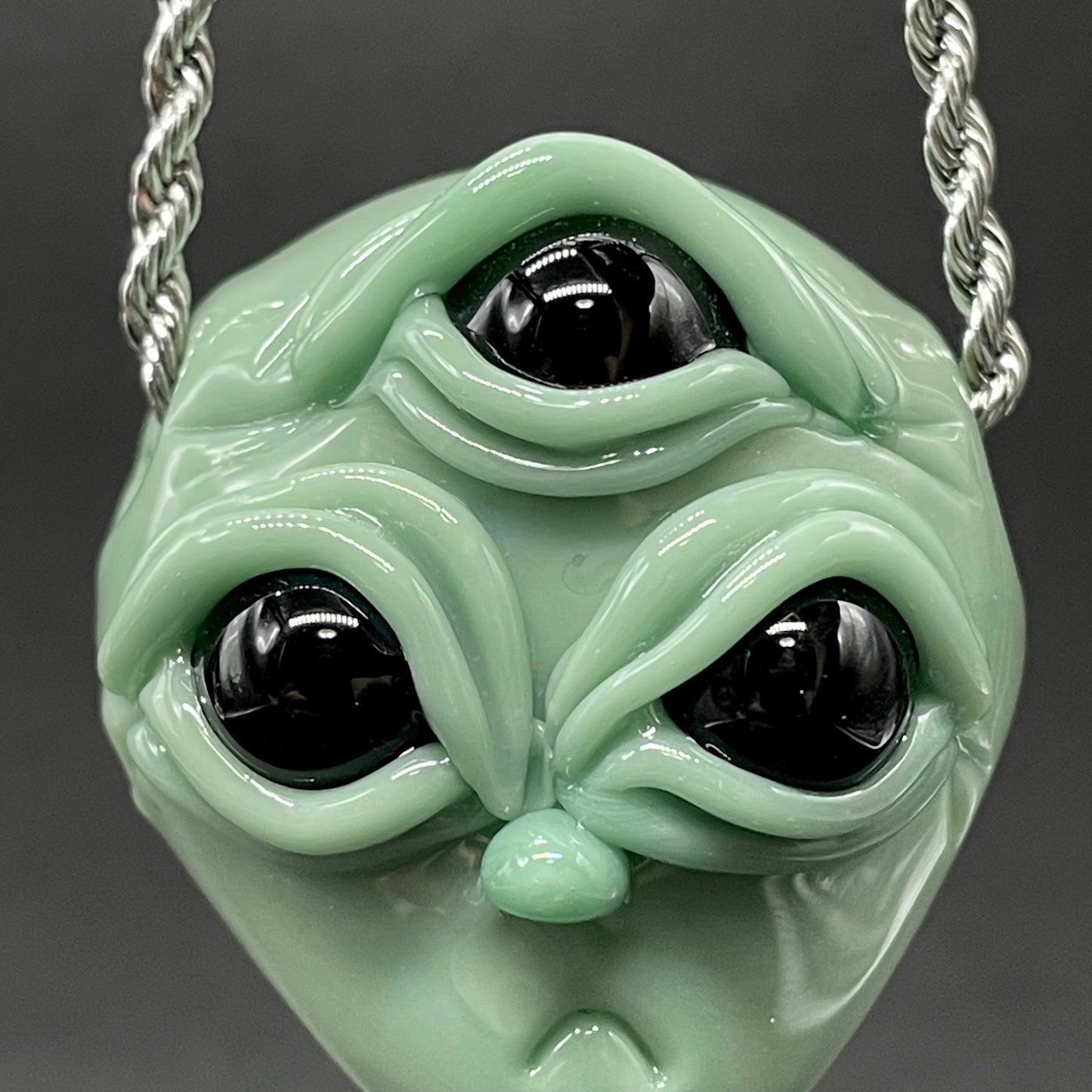 Time manipulating three eye glass alien pendant