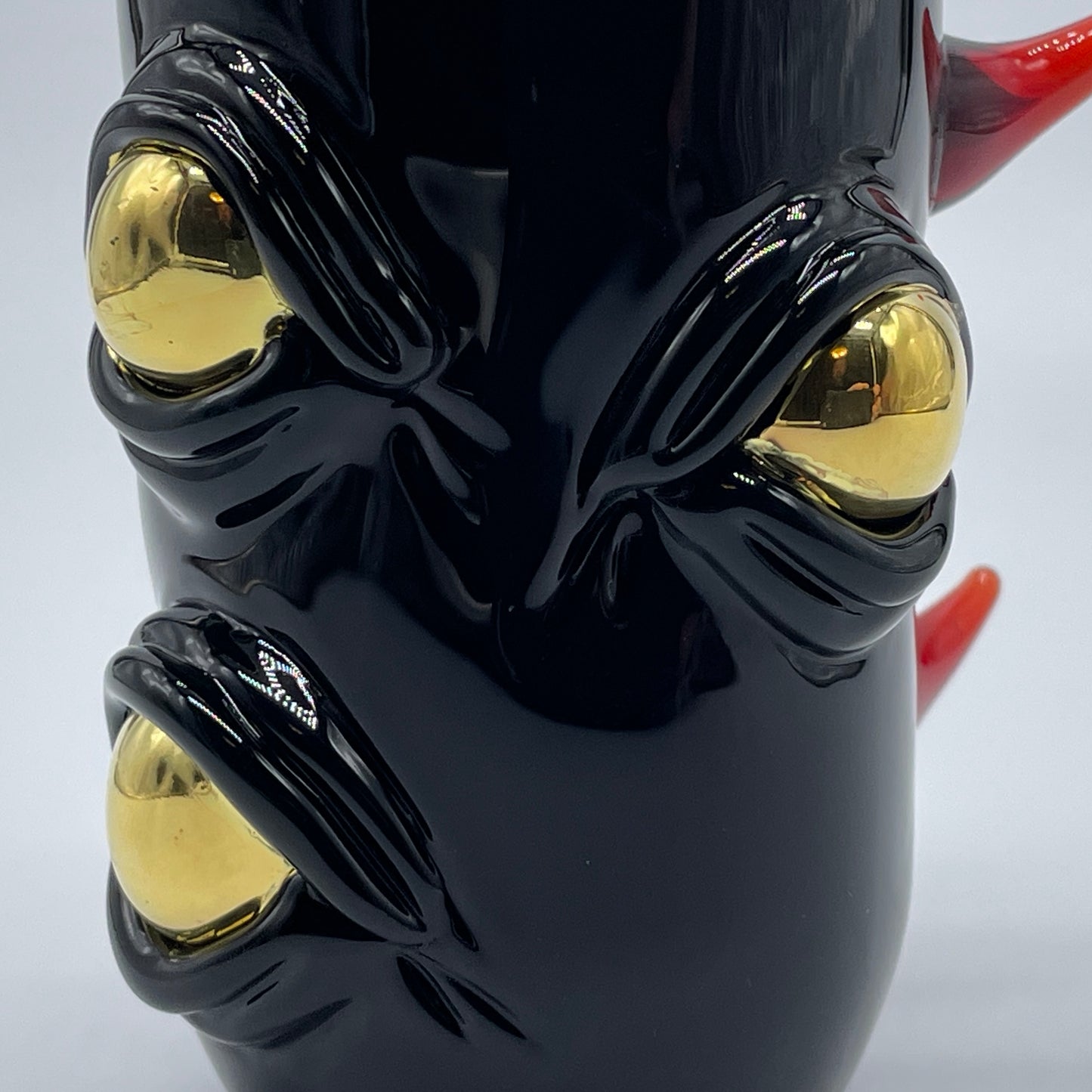 Close-up of Onyx cyclops shot glass - handcrafted glass