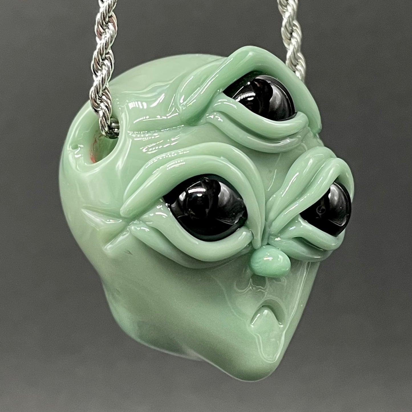 Time manipulating three eye glass alien pendant
