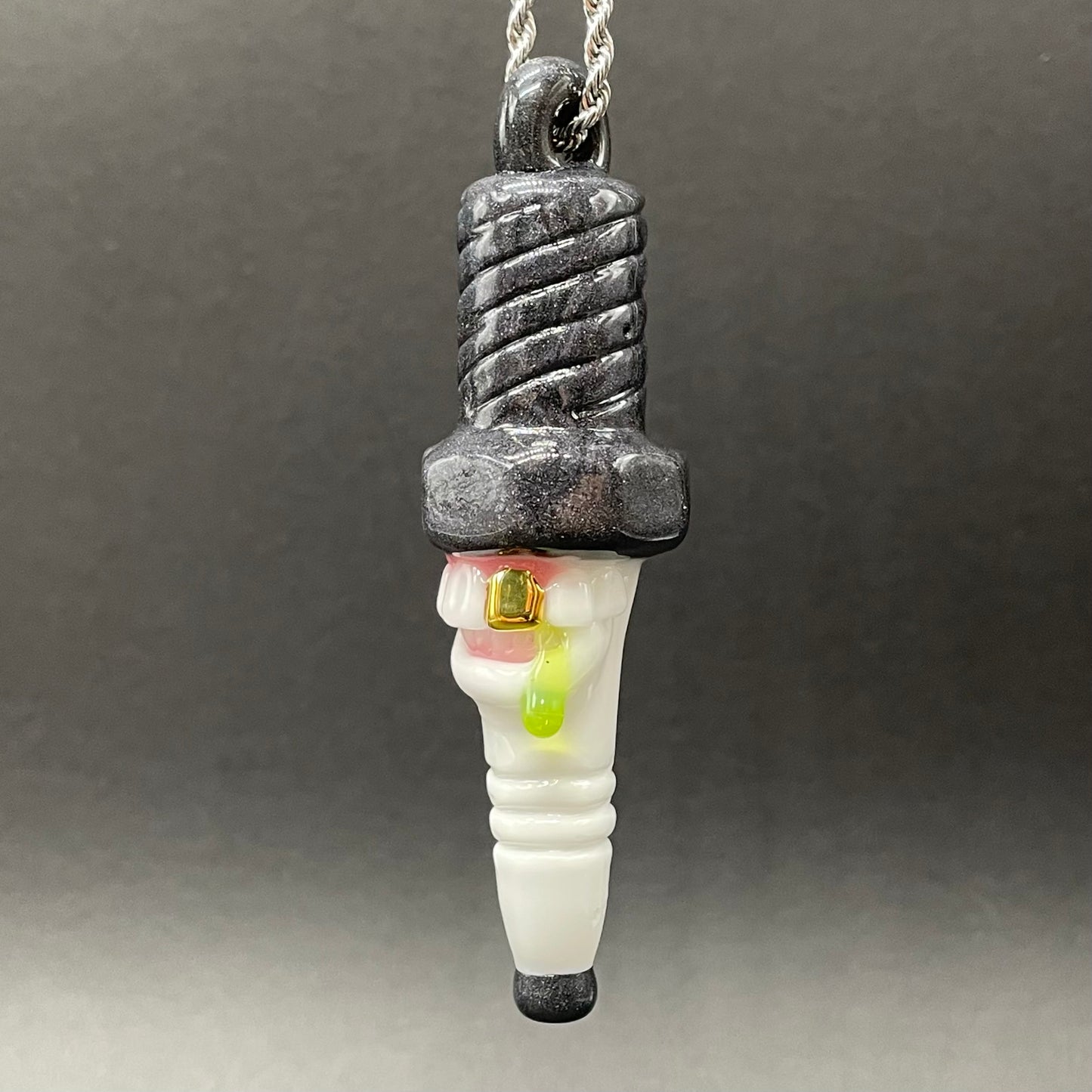 Close-up of Sparky the Glass spark plug pendant - handcrafted glass