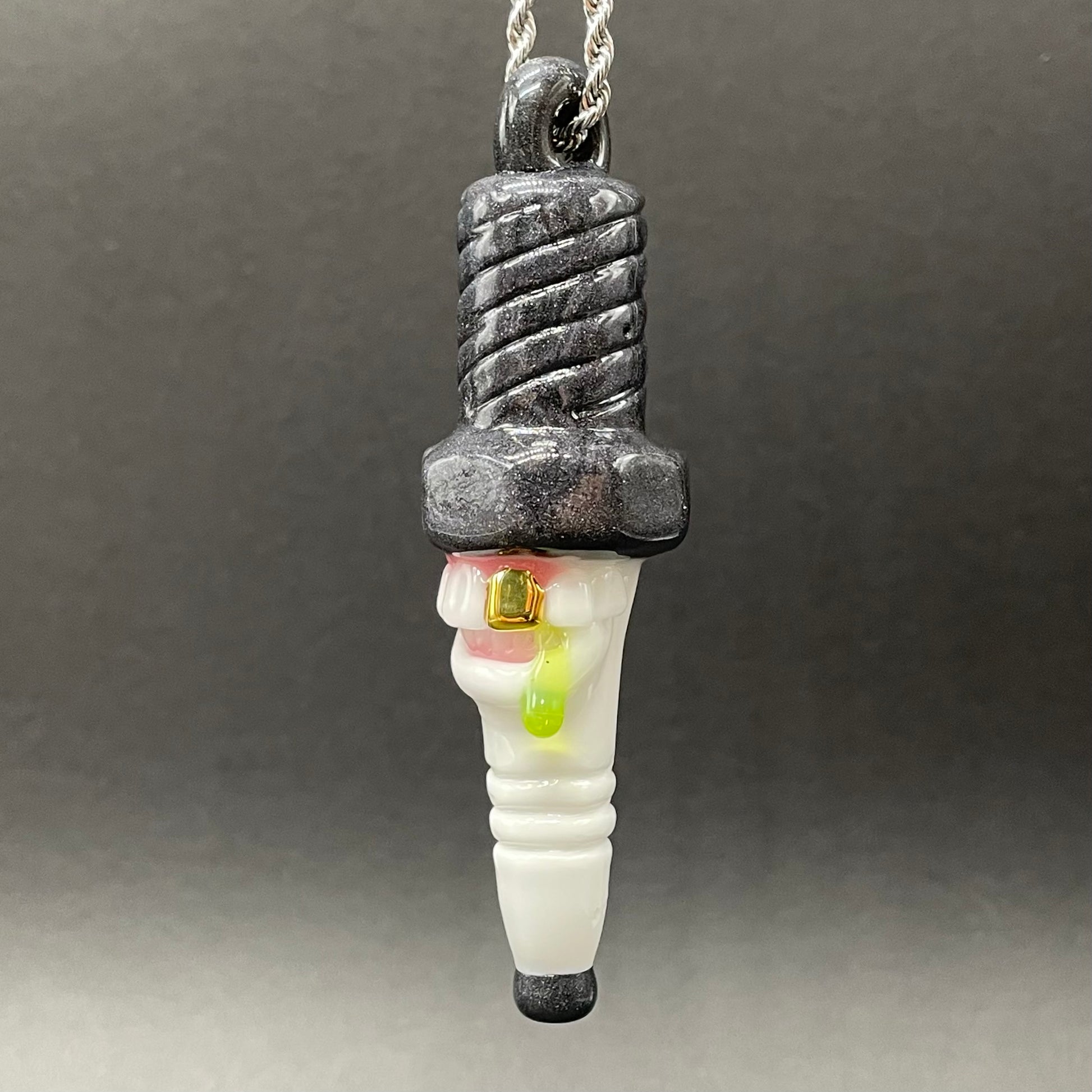 Close-up of Sparky the Glass spark plug pendant - handcrafted glass