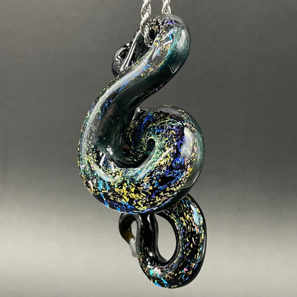Close-up of Dichroic rainbow sparkle snake pendant - handcrafted glass