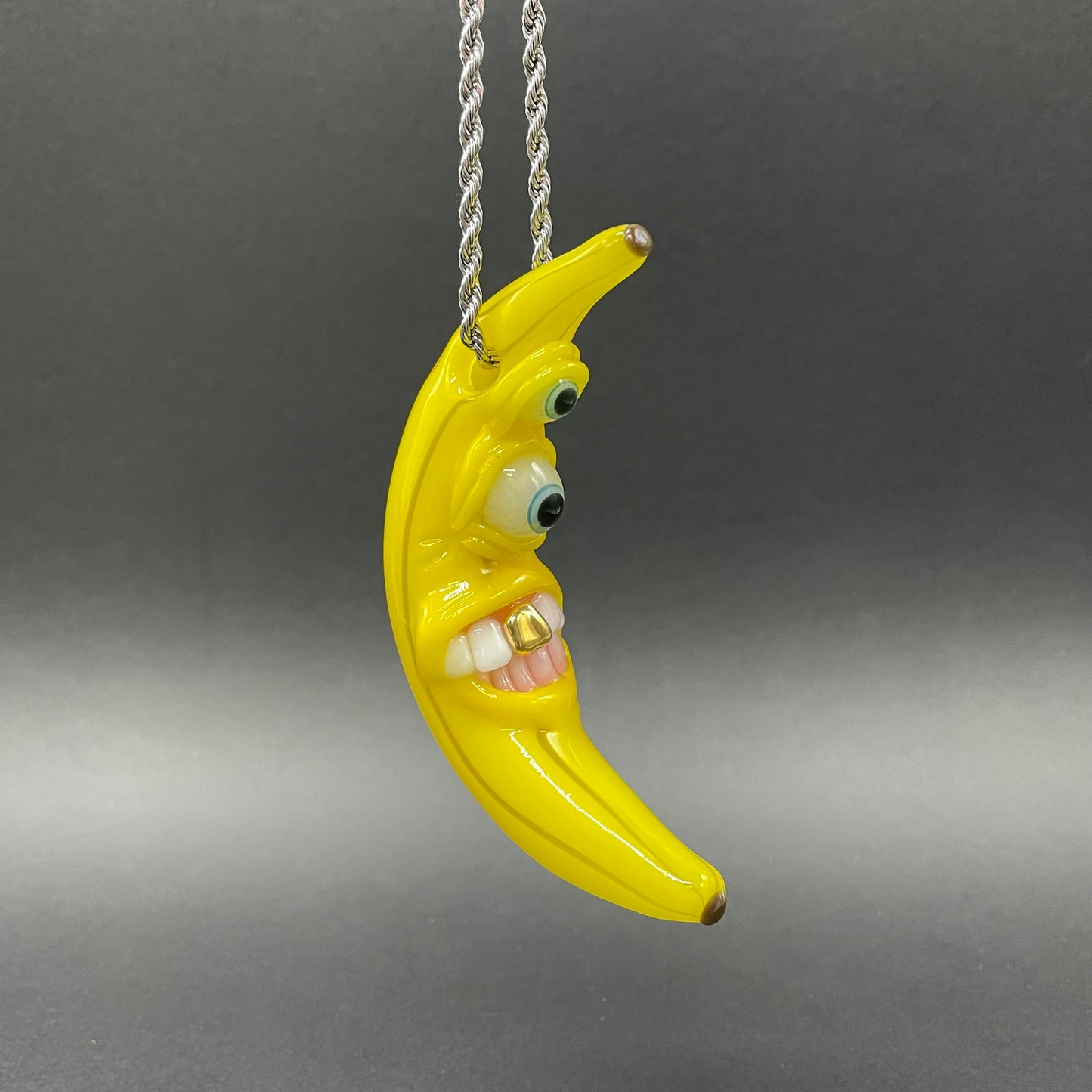 Grinning glass banana pendant