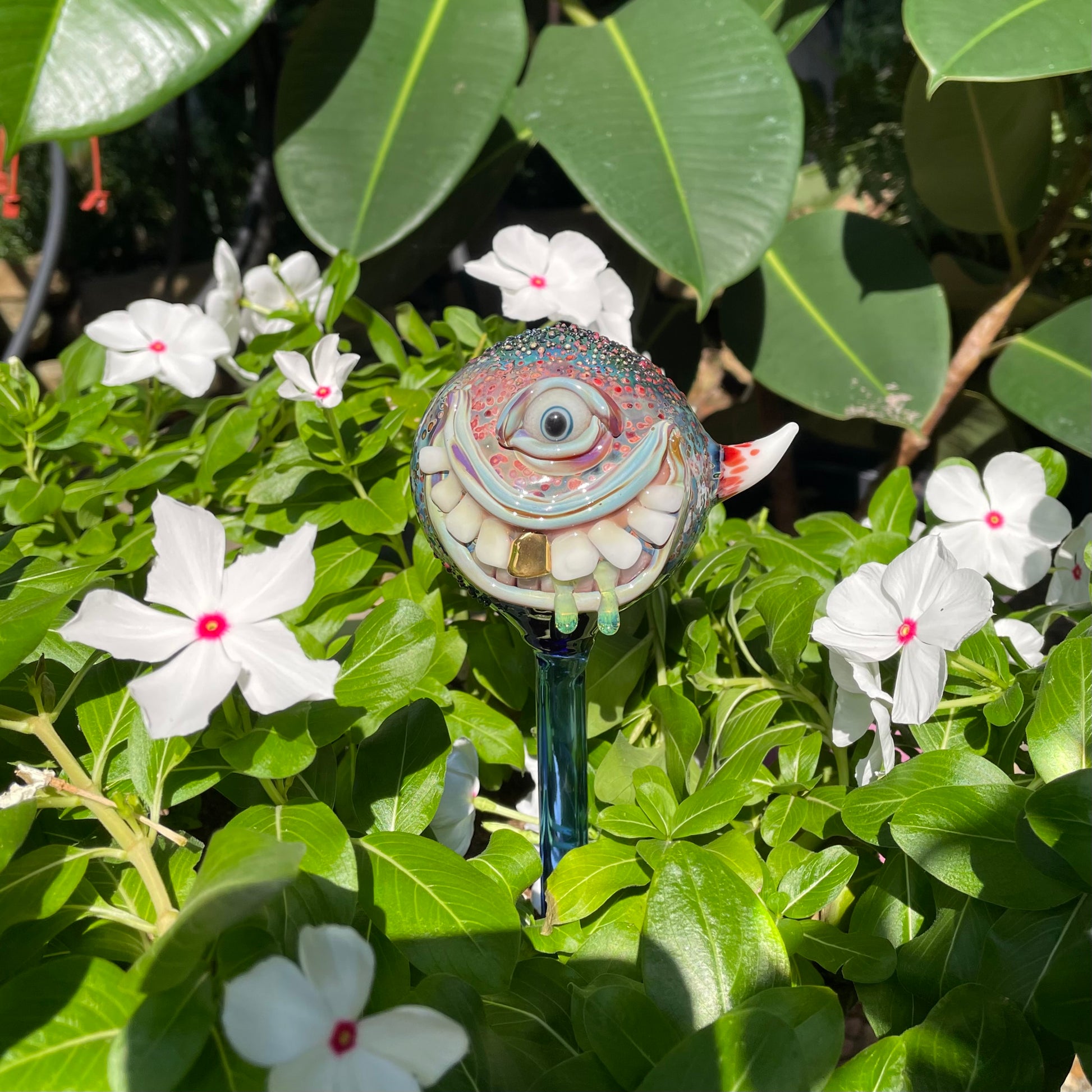 Hand Blown Glass Monster Watering Globe - round cyclops head, blue iris eye, white teeth, gold tooth, teal tongue drips, teal glass stake - Leviathan Glass
