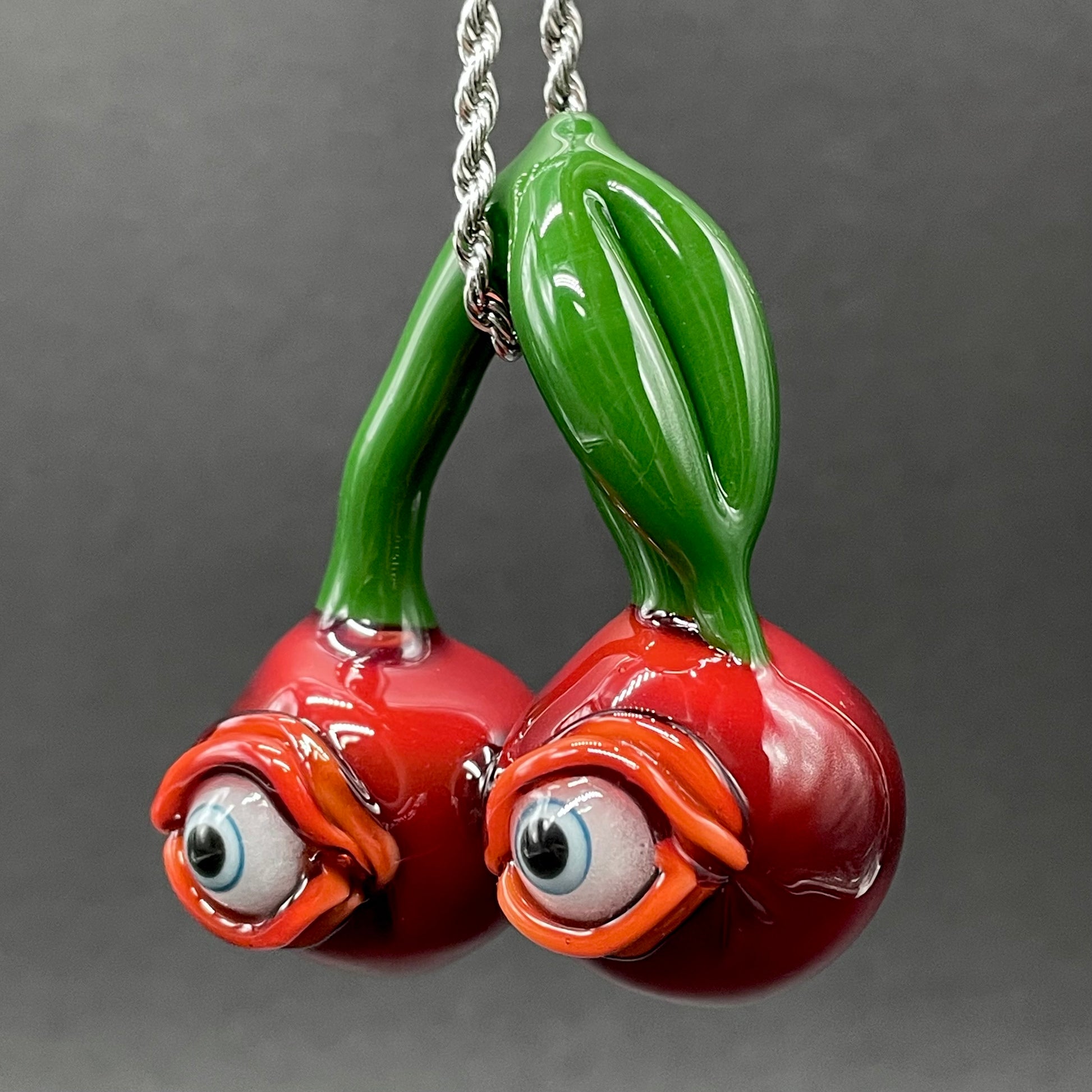 Close-up of Cherry flavored glass eye pendant - handcrafted glass