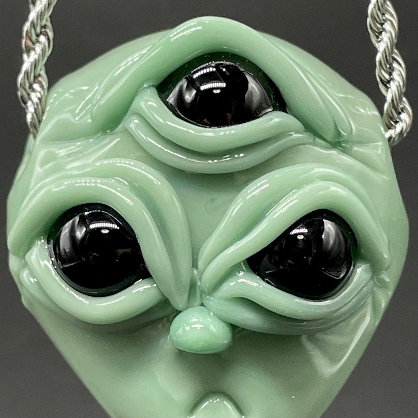 Time manipulating three eye glass alien pendant