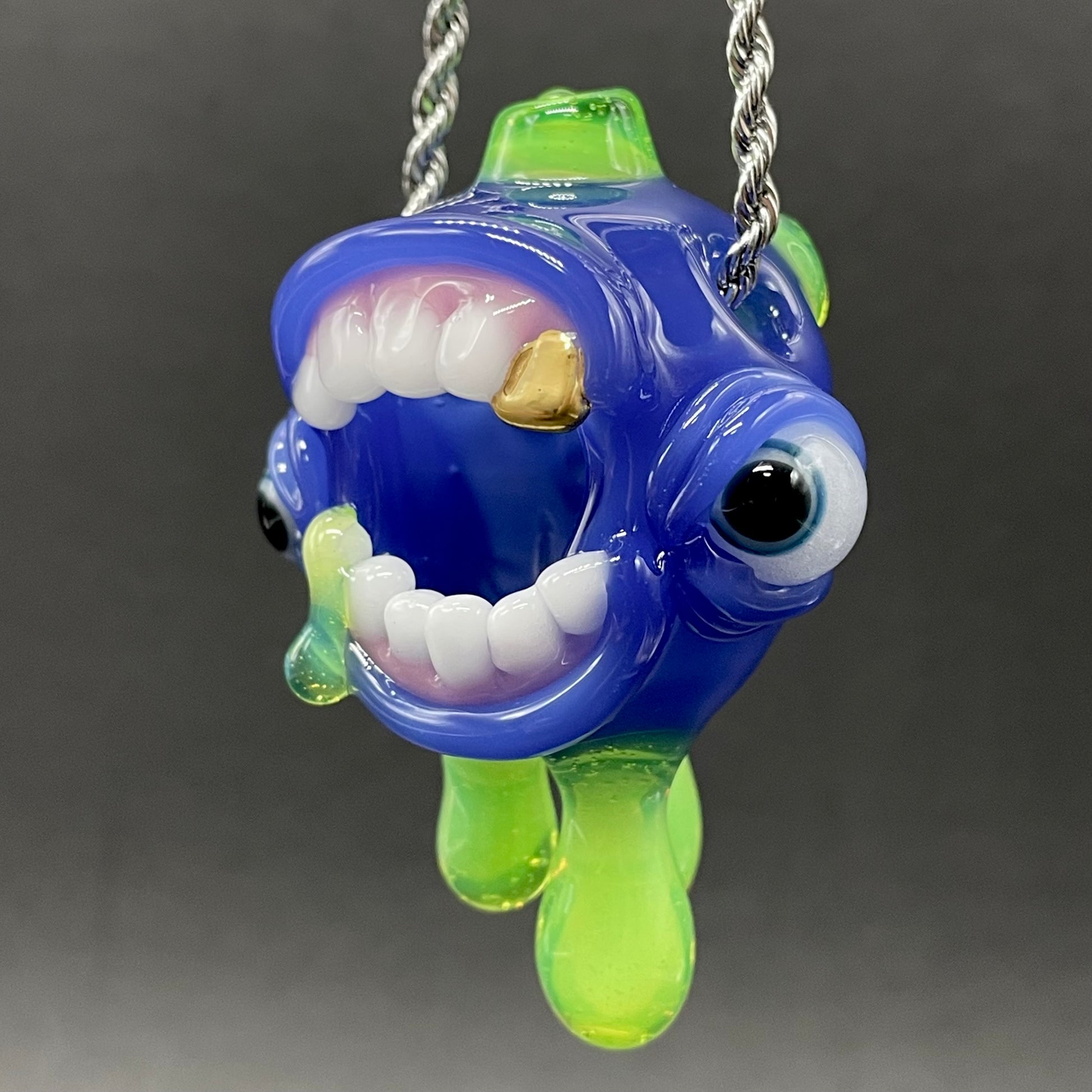 Close-up of Drippy screamer pendant - handcrafted glass