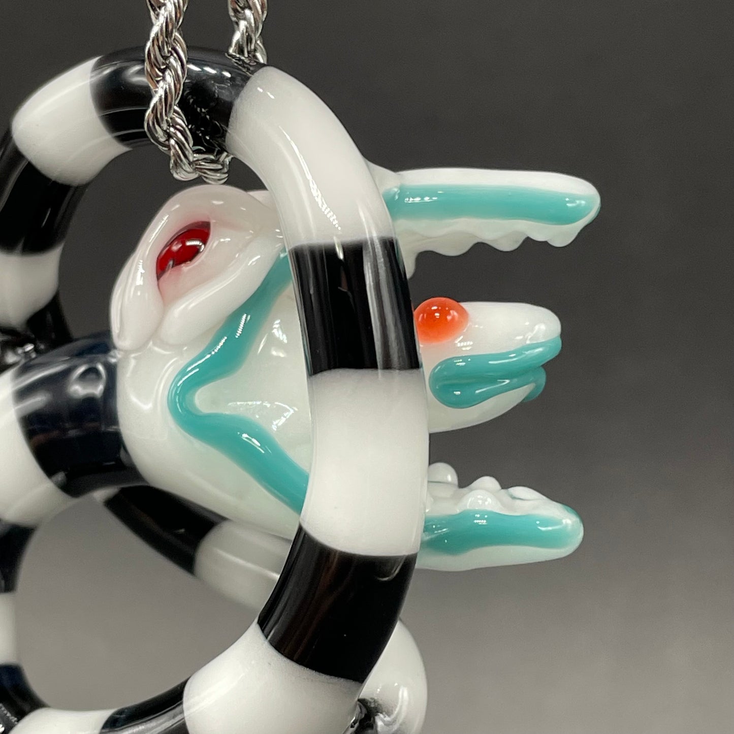 Beetlejuice Inspired handblown solid glass Sandworm sculpture - coiled black and white striped sandworm with white worm head, teal tongue, red eyes - Leviathan Glass