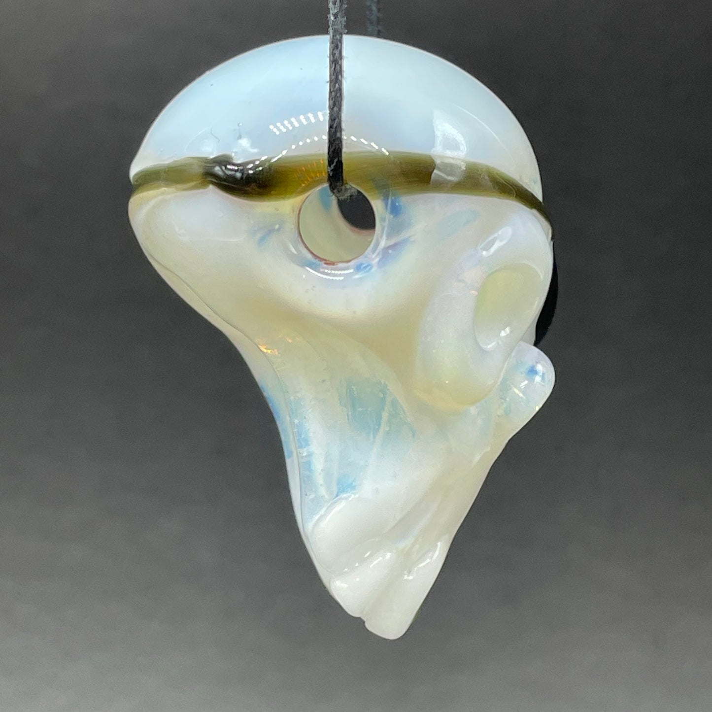 Close-up of one eyed Willie skull pendant - handcrafted glass