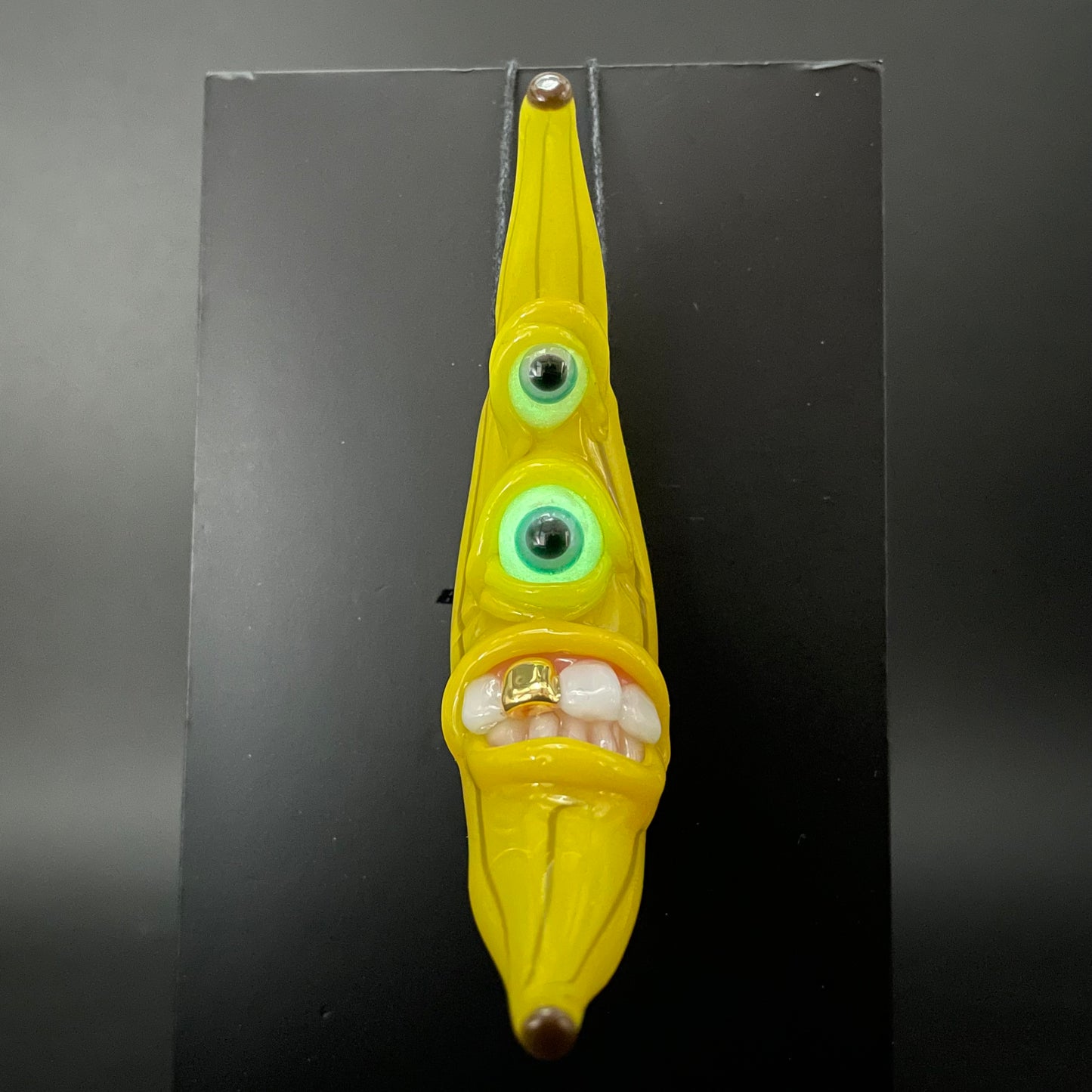 Grinning glass banana pendant