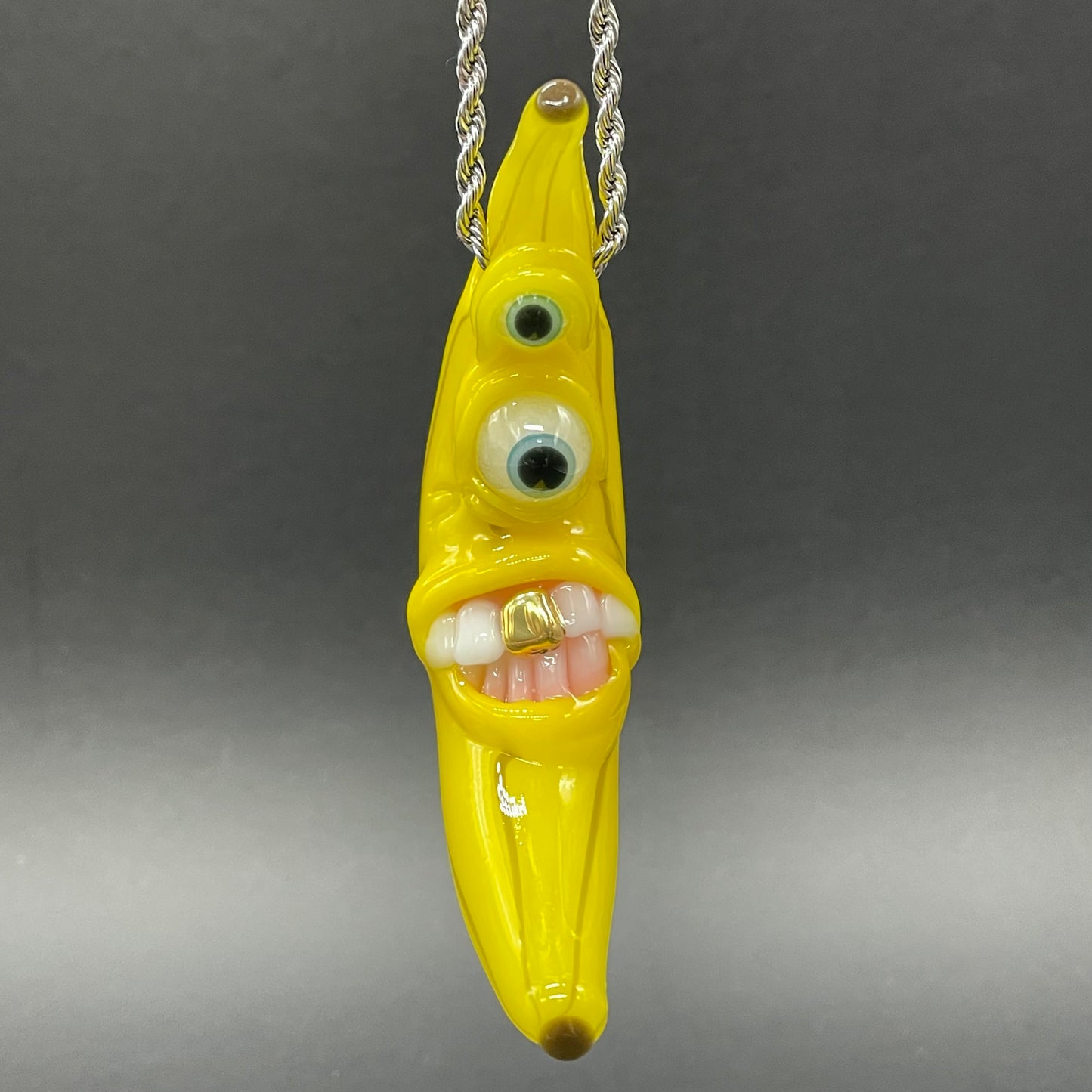 Grinning glass banana pendant