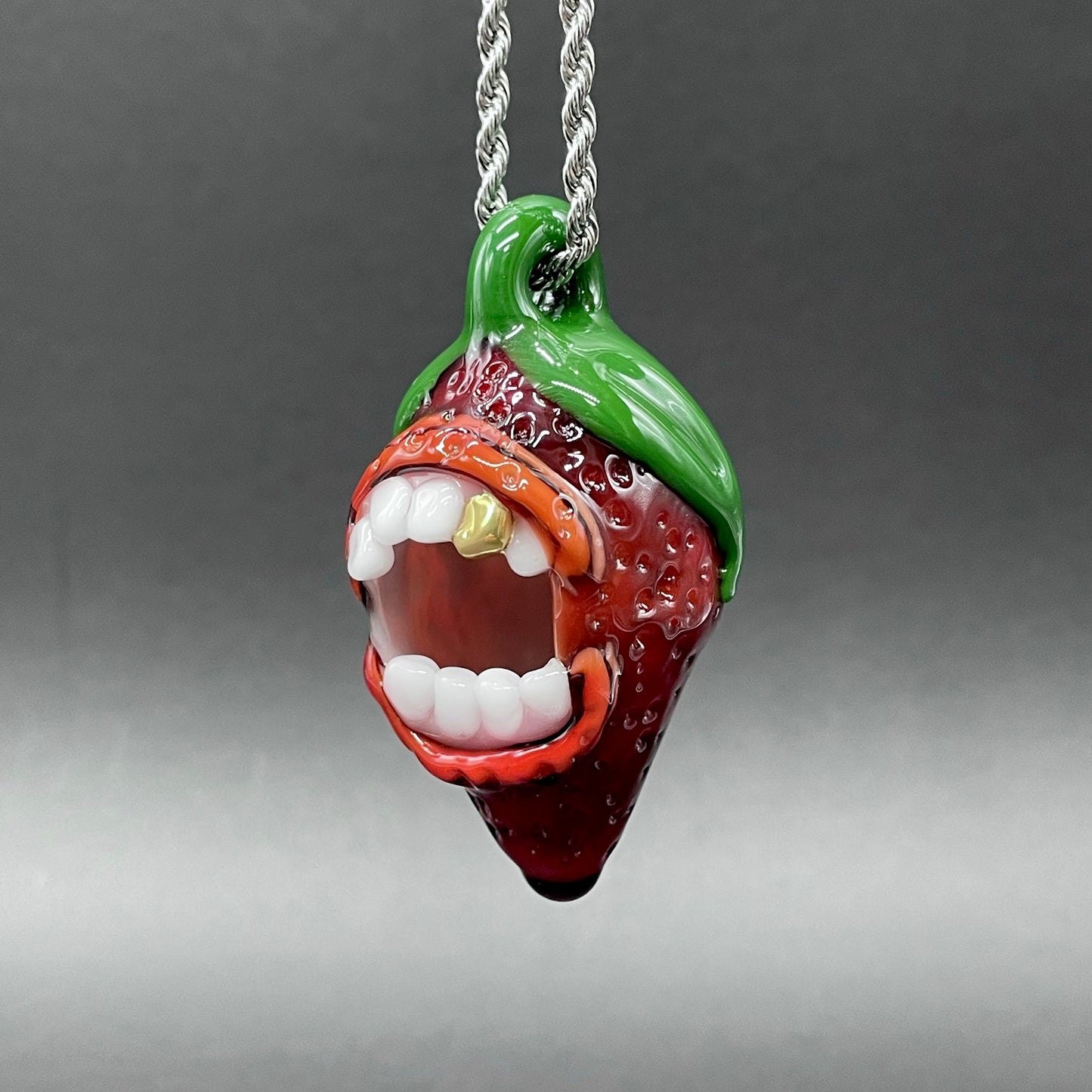 Hand-blown glass Screaming strawberry glass pendant by Leviathan Glass