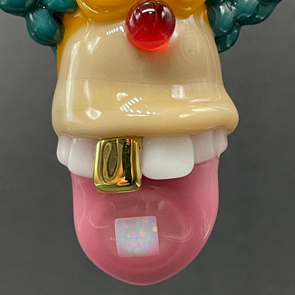 Close-up of Krusty the clown glass pendant with opal tab - handcrafted glass