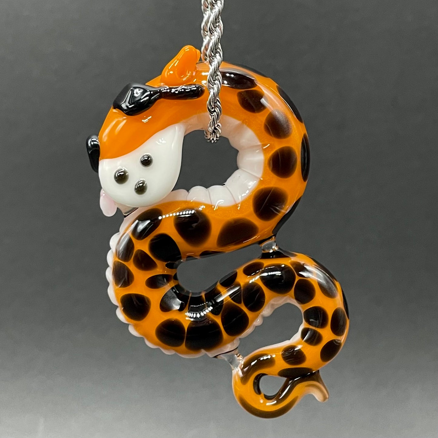 Close-up of Slithering Chester Cheetah glass pendant - handcrafted glass