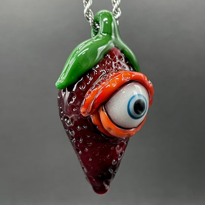 Close-up of Cyclops strawberry pendant - handcrafted glass