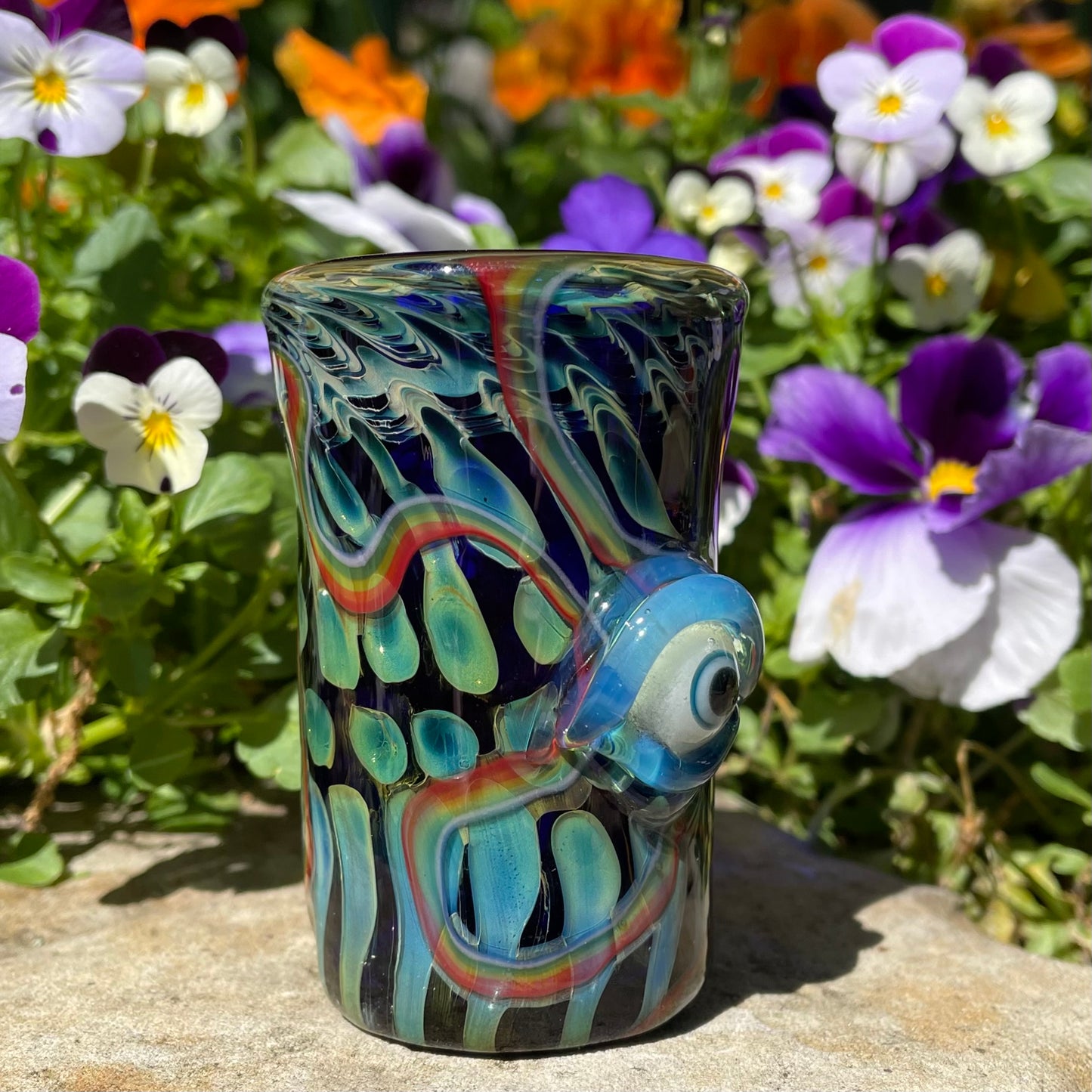 Close-up of Rainbow cyclops plant pot with drainage holes - handcrafted glass