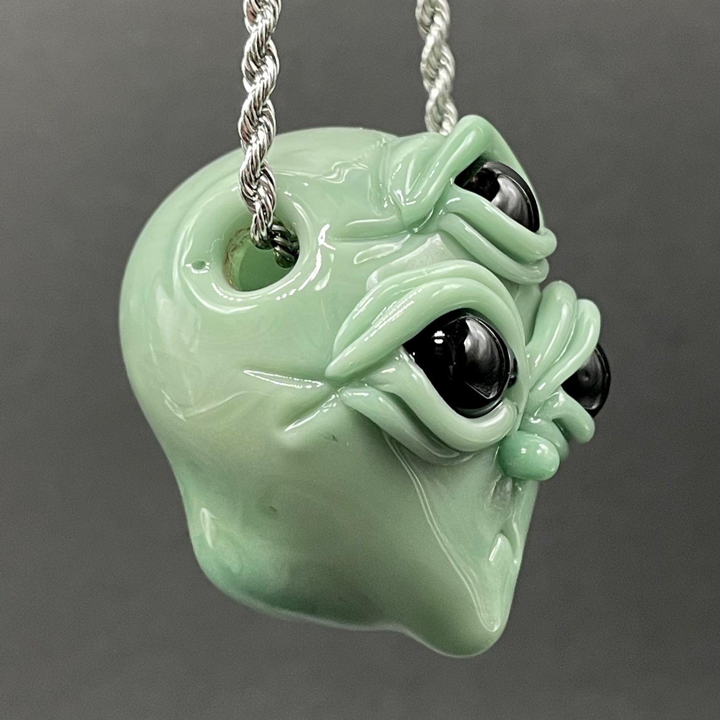 Time manipulating three eye glass alien pendant